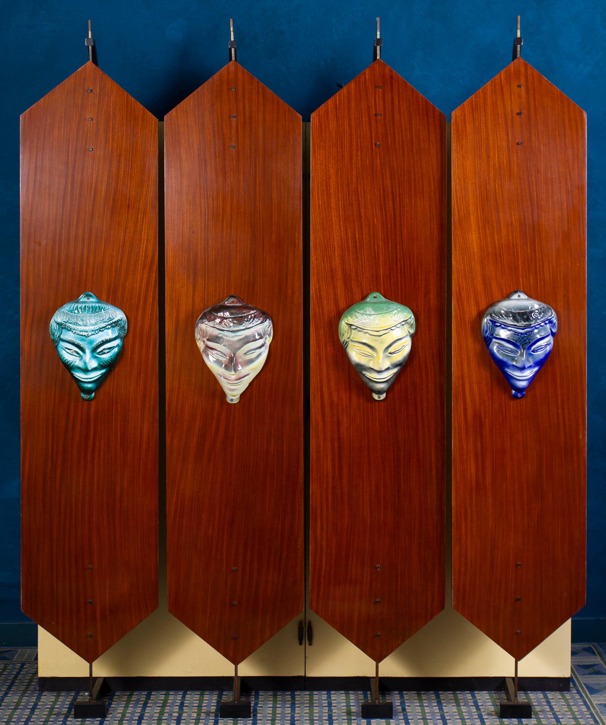Curious mid-century four reversible doors wardrobe with colorful Ceramic Masks. Italy 1950'
 Excellent vintage condition.