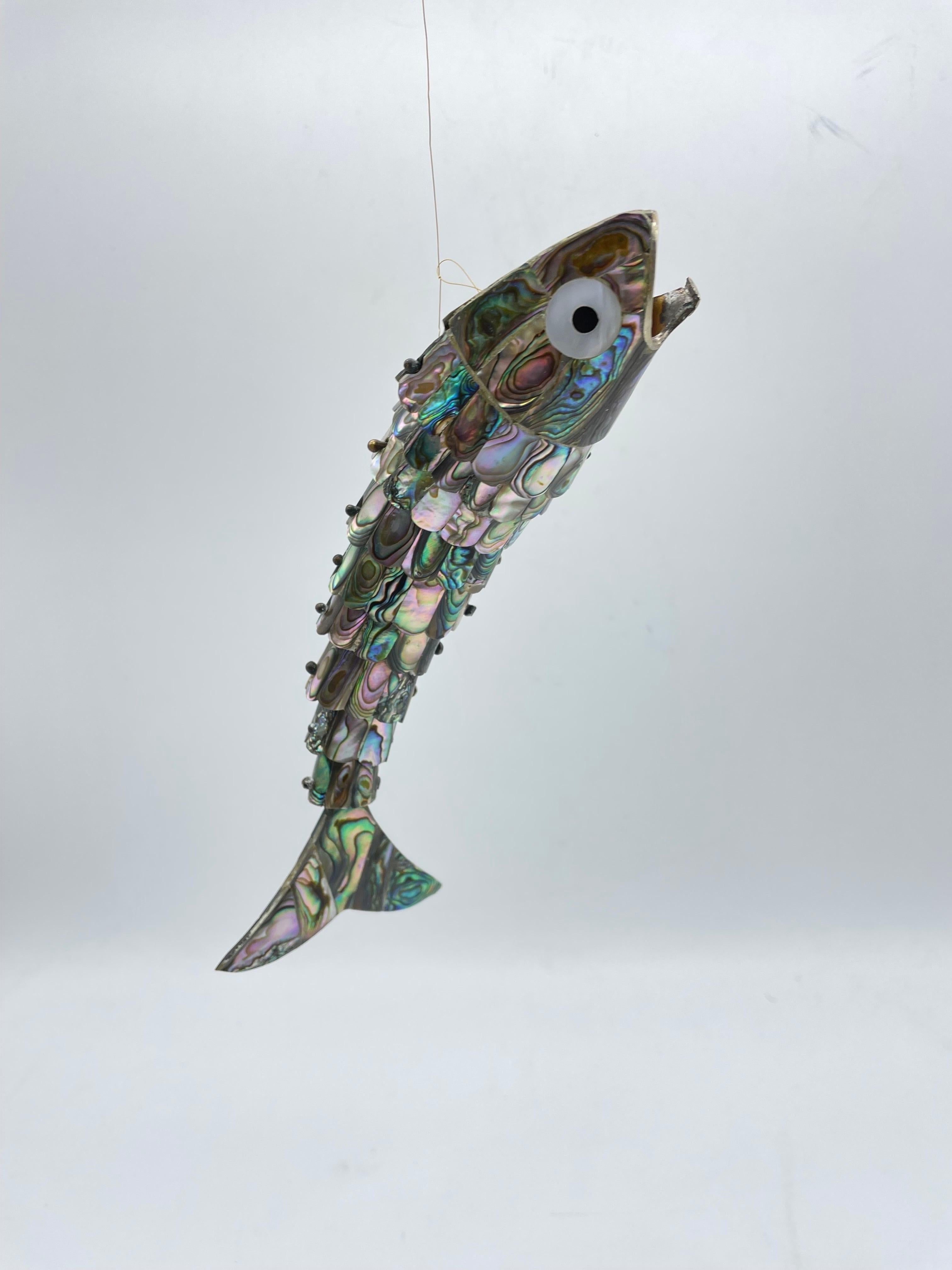 Curious wriggling fish made of mother-of-pearl

Fish made of mother of pearl veneer. Very fine and quality work. Fish assembled with moving elements.