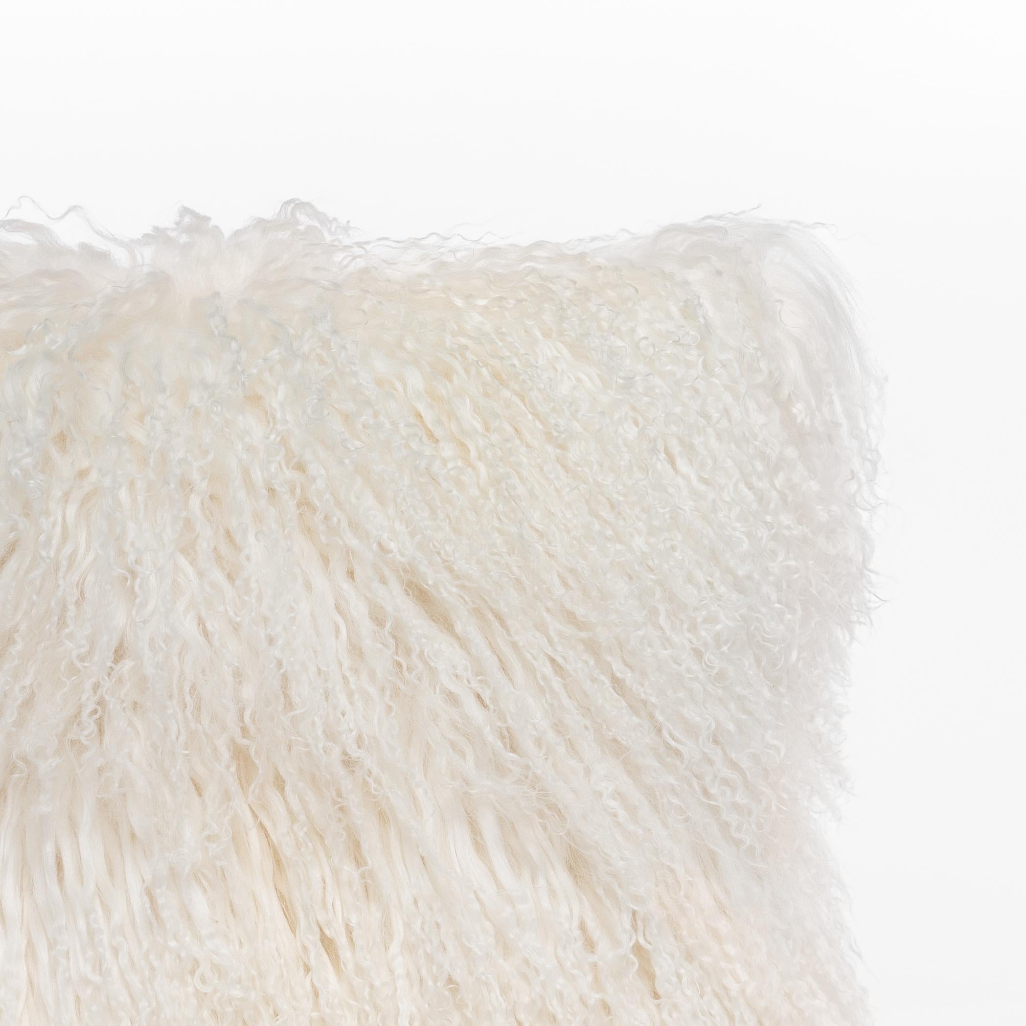 This cushion is handcrafted in our Atelier in Italy using only the best materials, starting from real Tibet Lamb fur. Its particular look allows this piece to both stand out or blend in your spaces, while keeping its nature of a soft and useful
