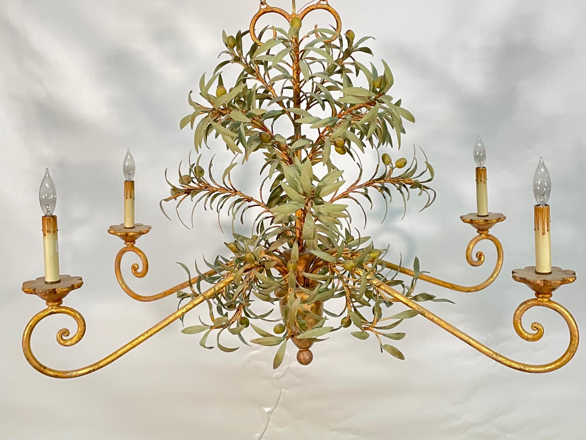 Vintage tole chandelier by Currey and Co. features sculptural leaves and berries and gold gilt finish. Very good condition with minor imperfections consistent with age.
 