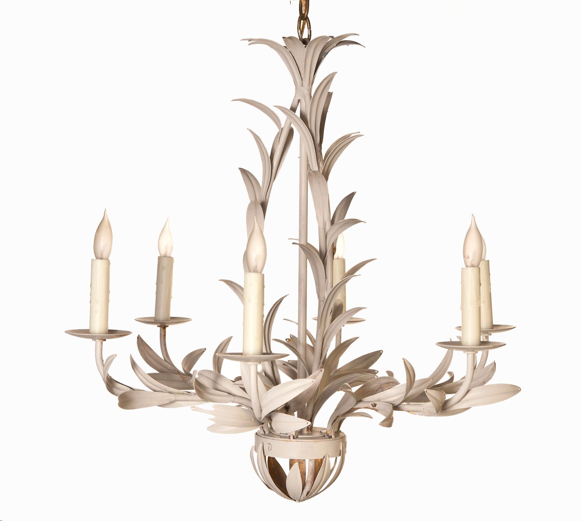 Dramatic leaf motif chandelier which has been hand painted in aged white finish over gilt metal. Playful yet glamorous. Featuring six lights and inspired by natural leaf shapes. Natural beeswax candle covers. Original canopy is included. The wiring