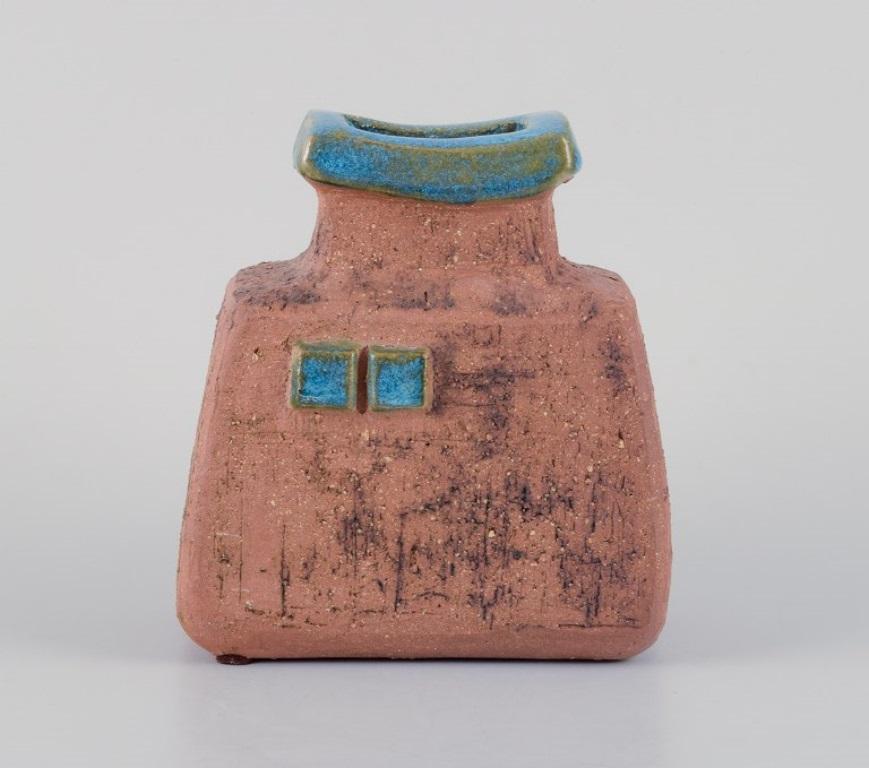 Curt Addin, own workshop, Swedish ceramicist. 
Unique ceramic vase in a modernist and stylish design. Chamotte clay, glaze in blue-green shades.
1970s.
In perfect condition.
Signed.
Dimensions: H 14.3 cm. x L 12.7 cm. x D 7.5 cm.