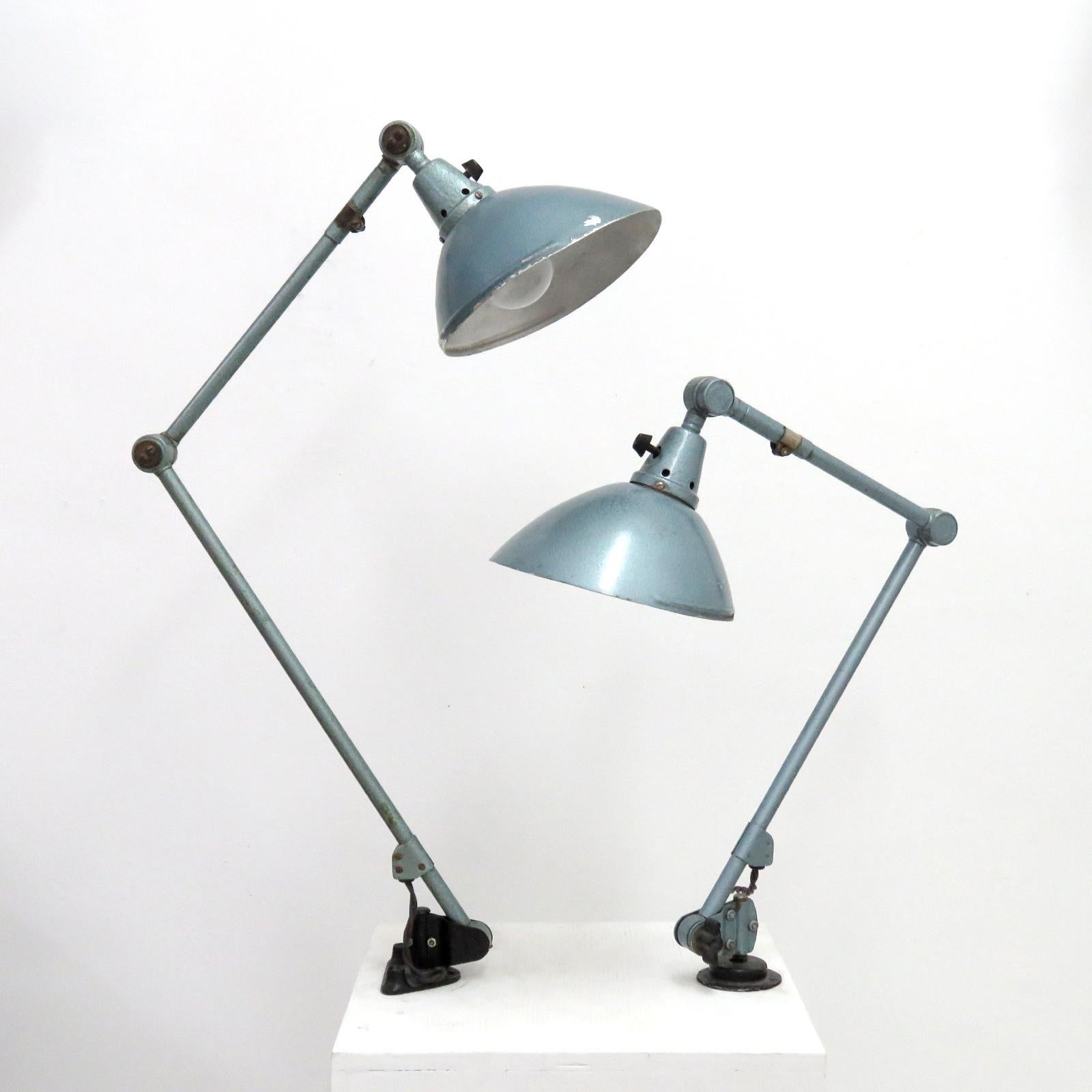 wonderful 1920s articulating table-mounted desk lamps by Curt Fischer for Midgard in original grey-green hammer finish and on/off turn switch on the shade, arm lengths of the smaller lamp 18