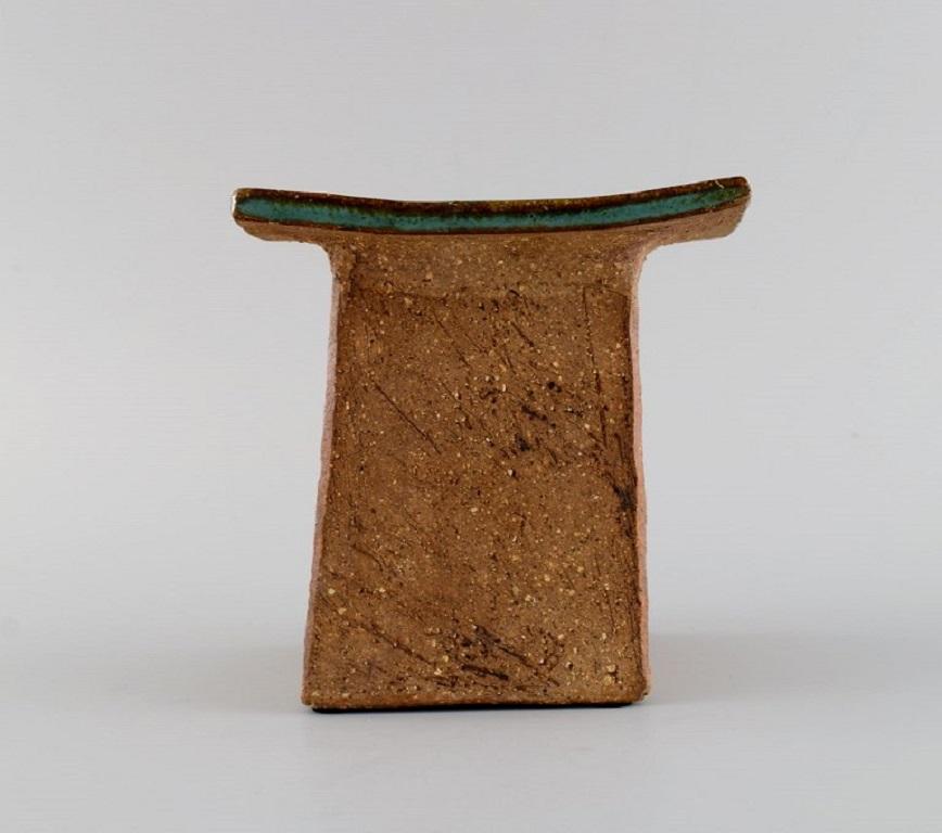 Curt M. Addin (1931-2007) for Glumslöv. 
Candle holder in partially glazed stoneware. 
Beautiful speckled glaze in shades of blue-green. Swedish design, 1960s / 70s.
Measures: 13 x 12 cm.
In excellent condition.
Stamped.