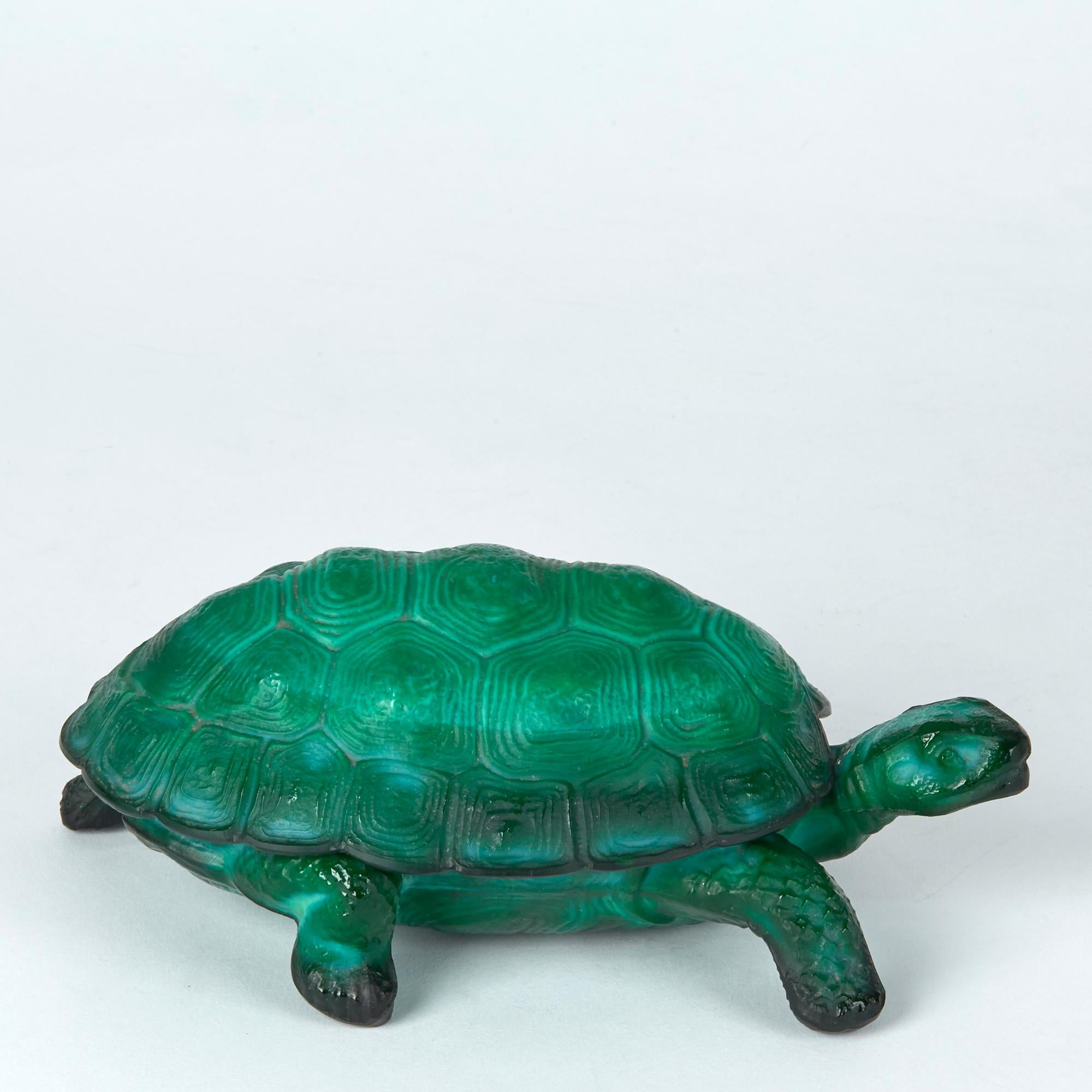 A stunning and rare Art Deco Bohemian Curt Schlevogt malachite green glass tortoise container moulded as a standing tortoise with a lift off fitted shell dating from circa 1930. The tortoise is well detailed with matted textures and is not marked.