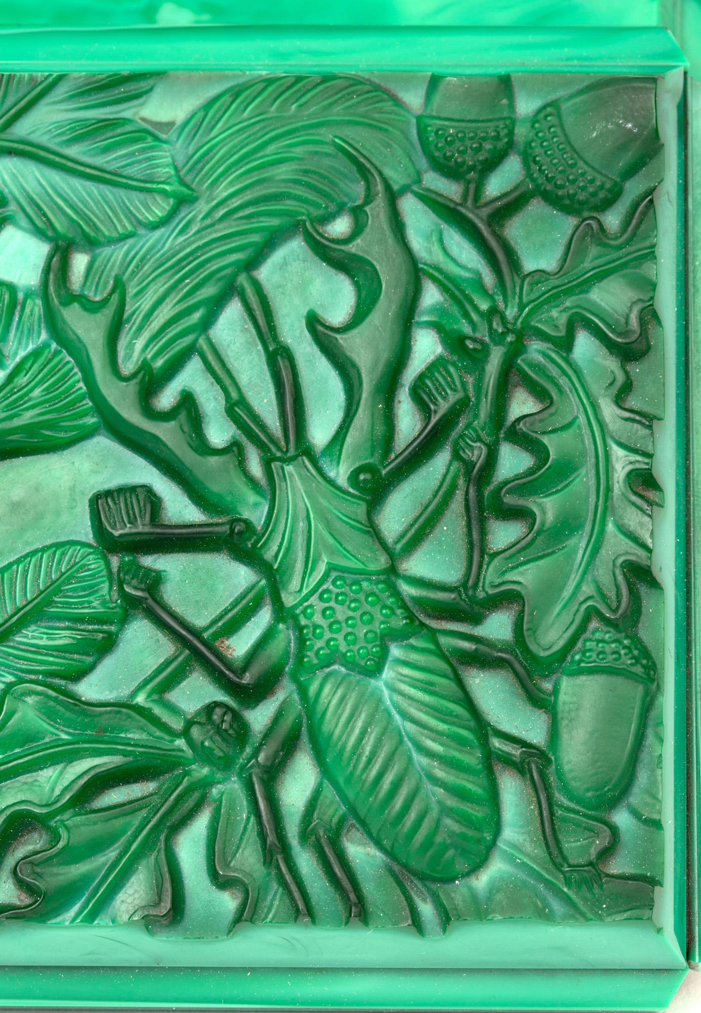 A stunning Art Deco Czech malachite green glass lidded box by Curt Schlevogt dating from circa 1930. The rectangular shaped box has panel cut sides with a hinged cover moulded in deep relief with a squirrel perched on a branch and gathering nuts and