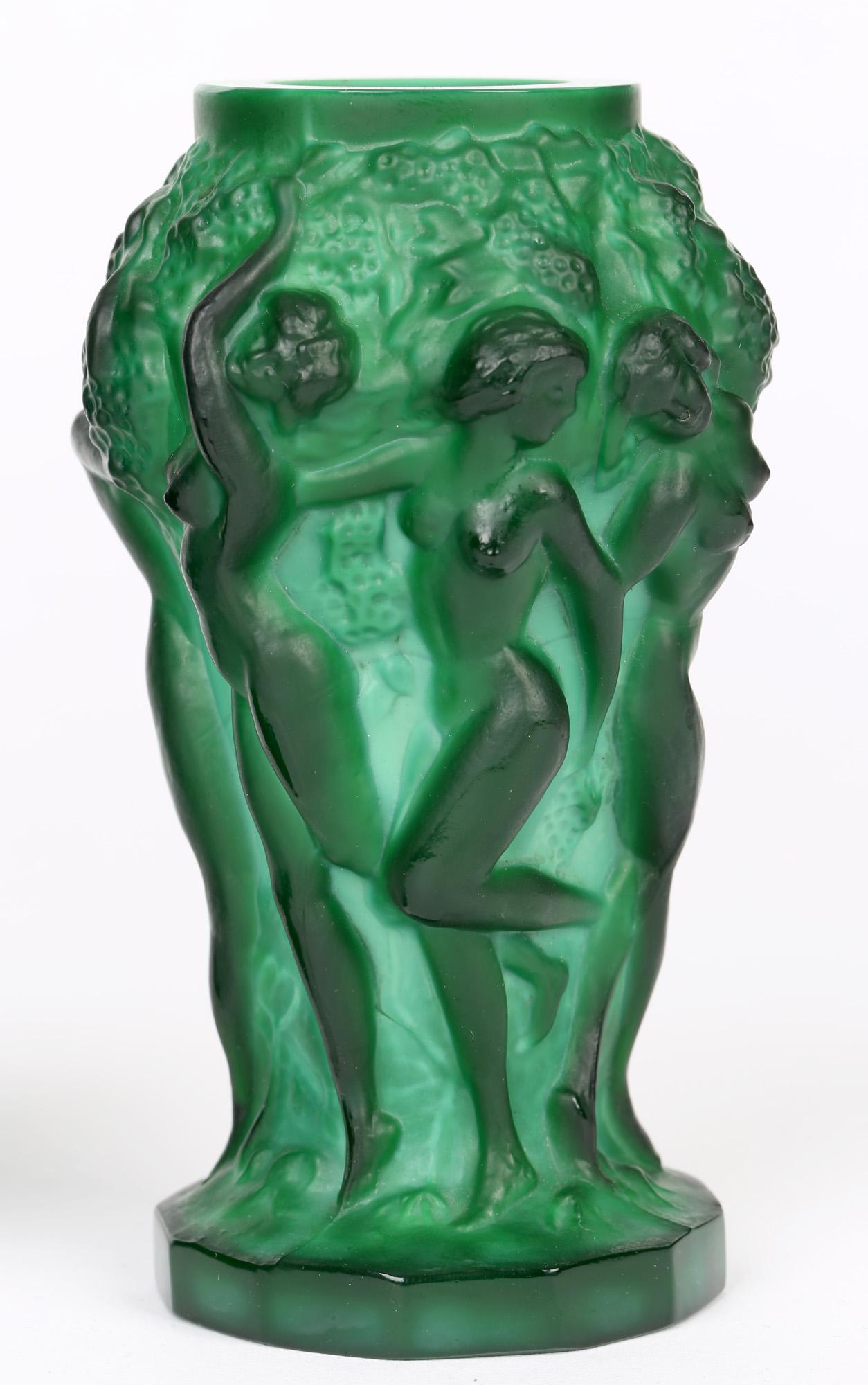 A very stylish pair Bohemian Art Deco green malachite glass vases with nude maidens picking grapes by Curt Schlevogt and dating from around 1930.The vases are heavily molded with flat cut twelve sided bases with six nude maidens in relief picking
