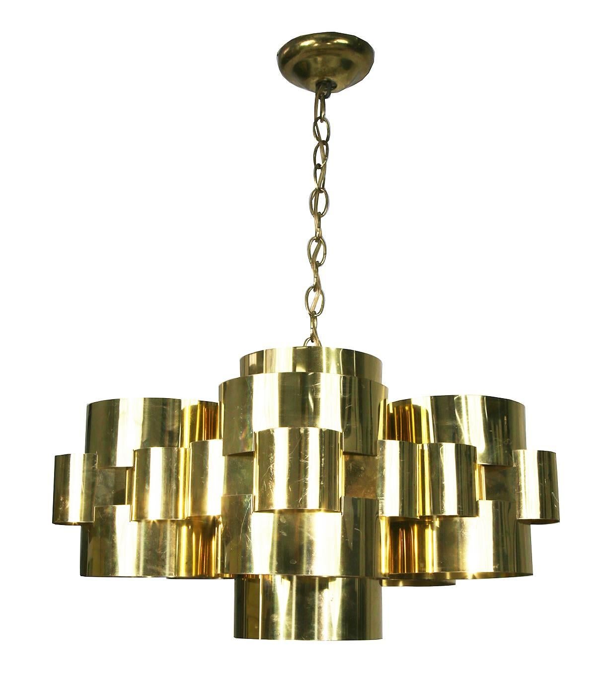 Signed Curtis Jere chandelier comprised of circular polished brass sheets grouped together to make a heavenly cloud formation.