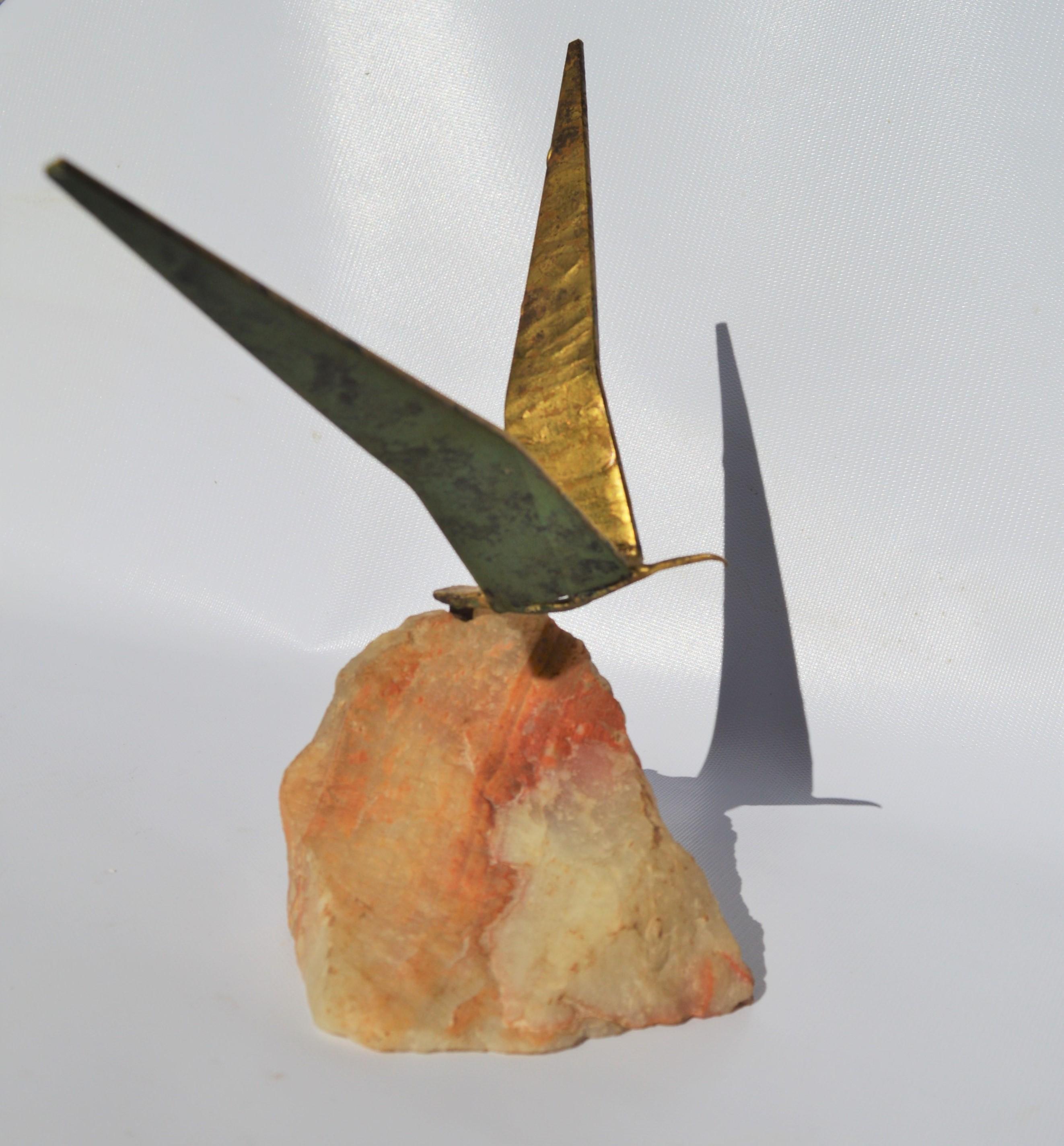 This delightful Curtis Jere original Brutalist brass bird in flight is Minimalist and striking - and casts beautiful shadows. The brass contrasts beautifully with the quartz plinth base. Signed by the artist and dated 1968 on the and in excellent