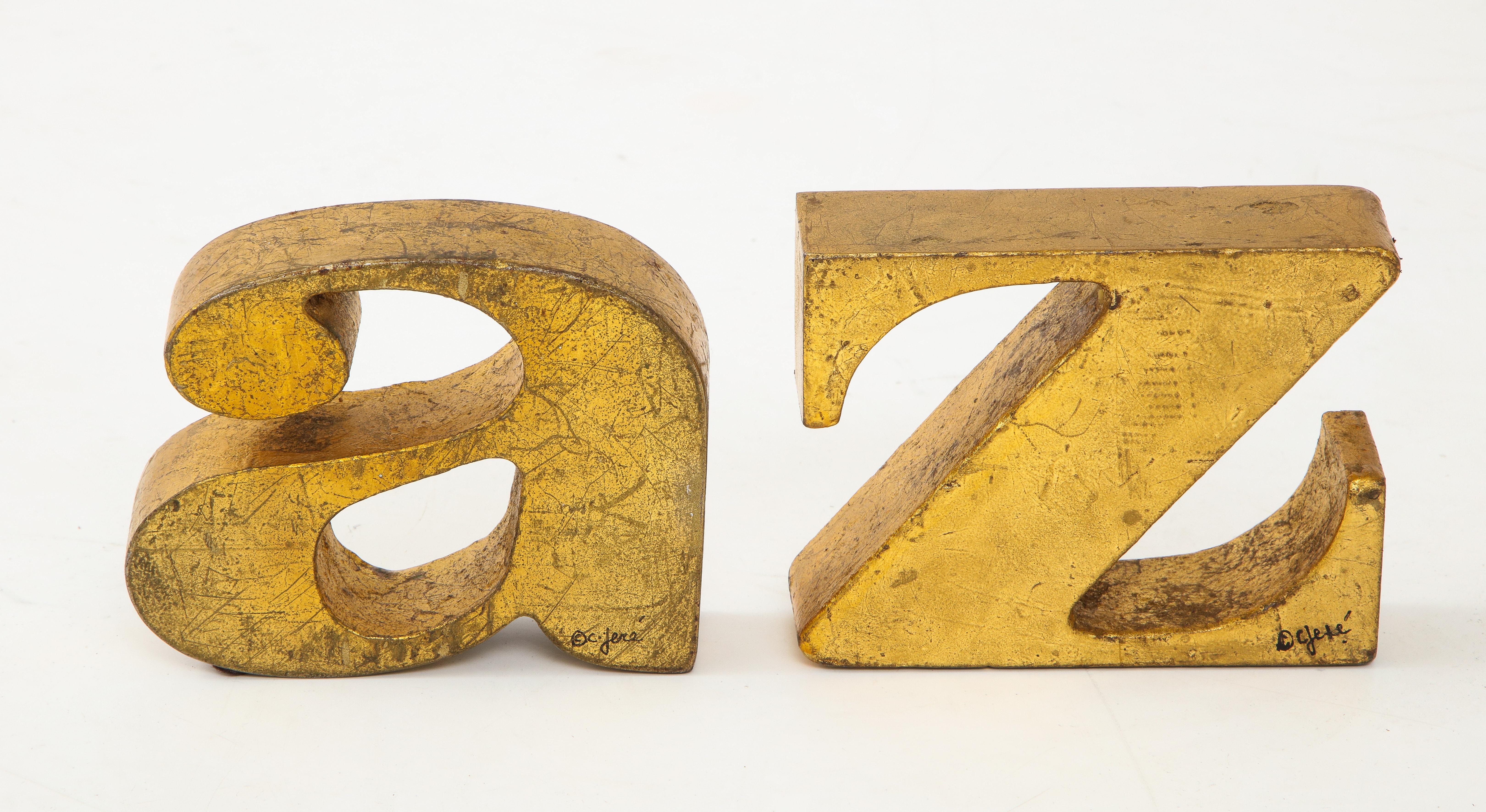 1970s Mid-Century Modern solid iron with gold leaf finish. Both of them are signed and labeled.