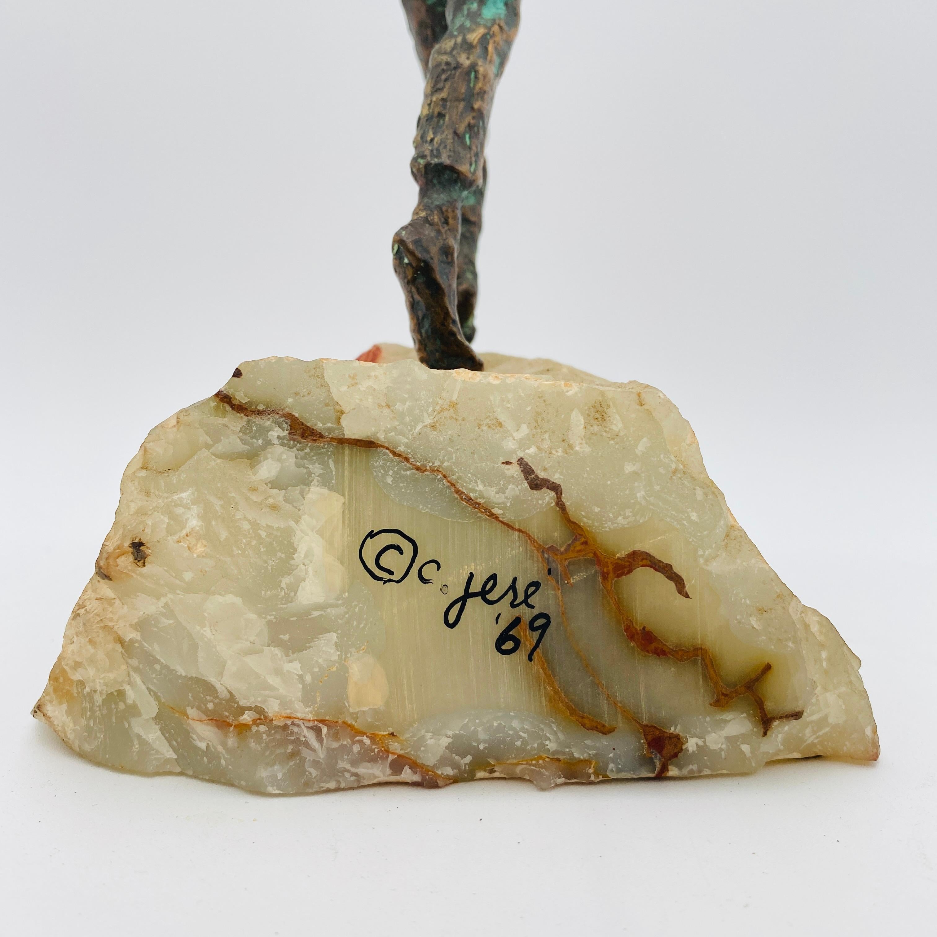 Rare sculpture of boy holding balloons by Curtis Jeré, signed 1969. Composed of bronze on an alabaster base. Expressive metal work with aged patina throughout. Metallic Strings contain soldered metal drops to accent the moving colorful balloons.