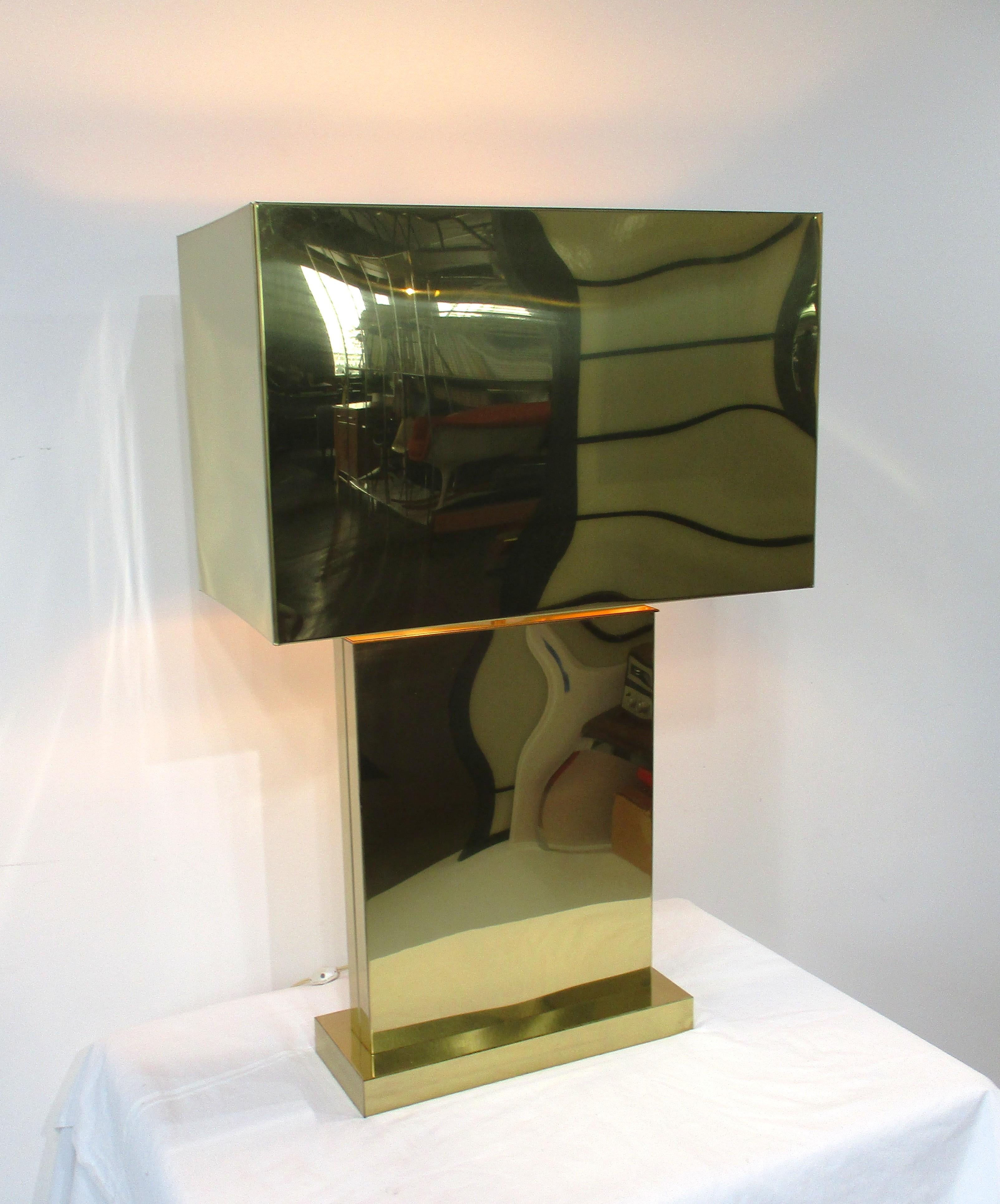 A sophisticated Mid Century Modern brass table lamp with large box shade making this quite the statement piece in any room setting. Polished with matching base this exceptional lamp is signed and dated by the maker Jere 1976 to the inside lower edge