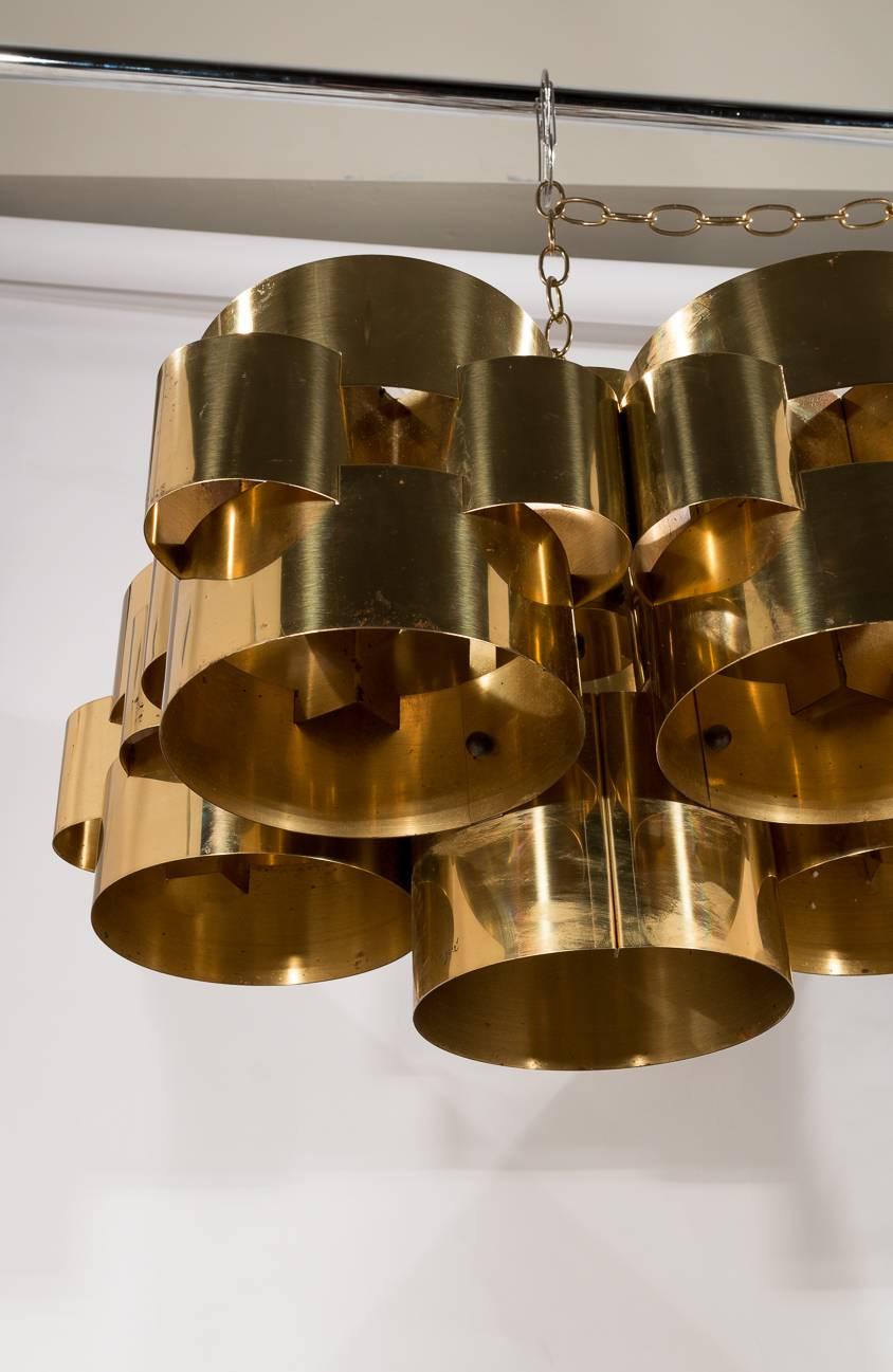 A 1970s Chandelier made from brass. It gives a beautiful golden glow when lit by its five-light bulbs. C. Jere made an art of brass and metal throughout the 1950s, 1960s and 1970s. This piece is in very good original condition. There is some light