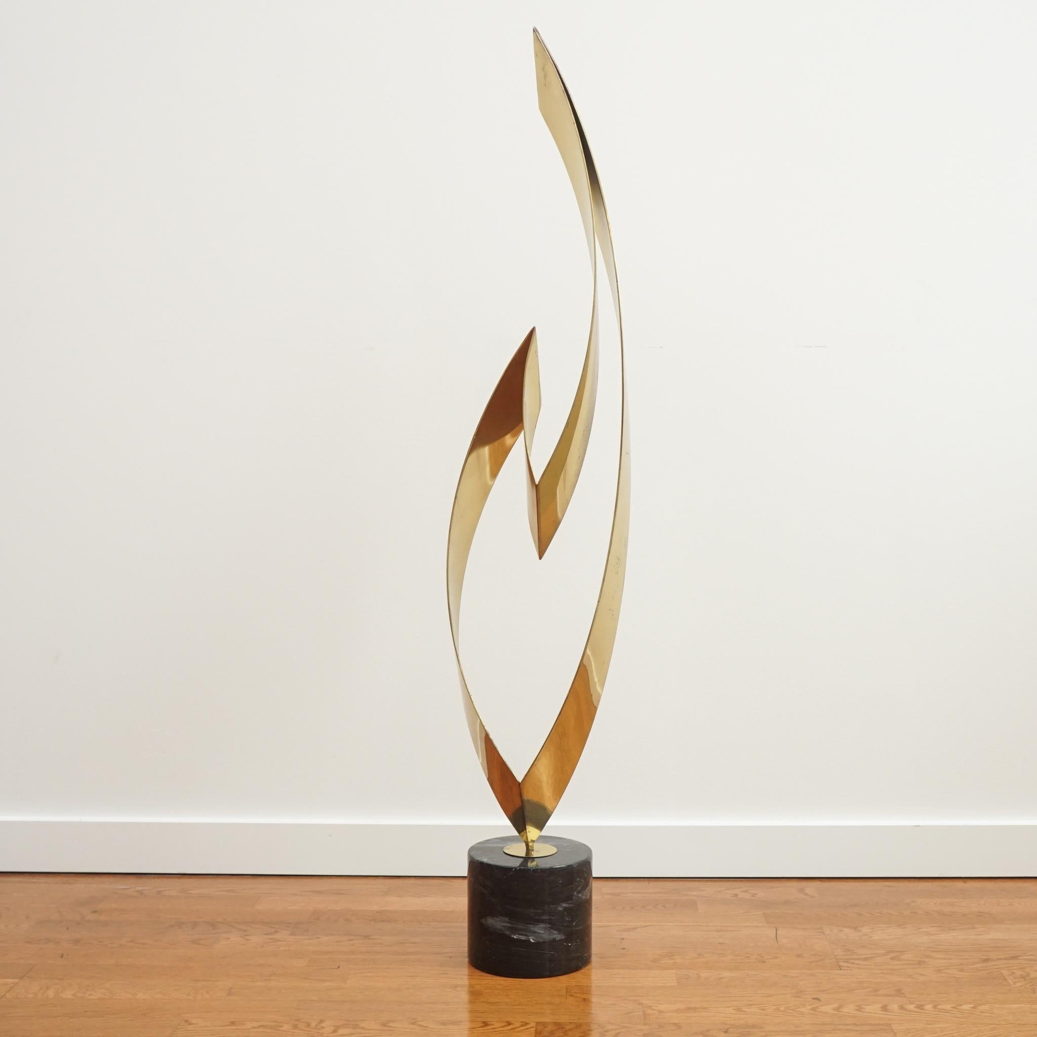 Dramatic in both its appearance and scale, this Eternal Flame brass sculpture is signed by Curtis Jere and dated 1984. It sits on a polished marble base making it perfect for display on a pedestal or a console or center hall table.