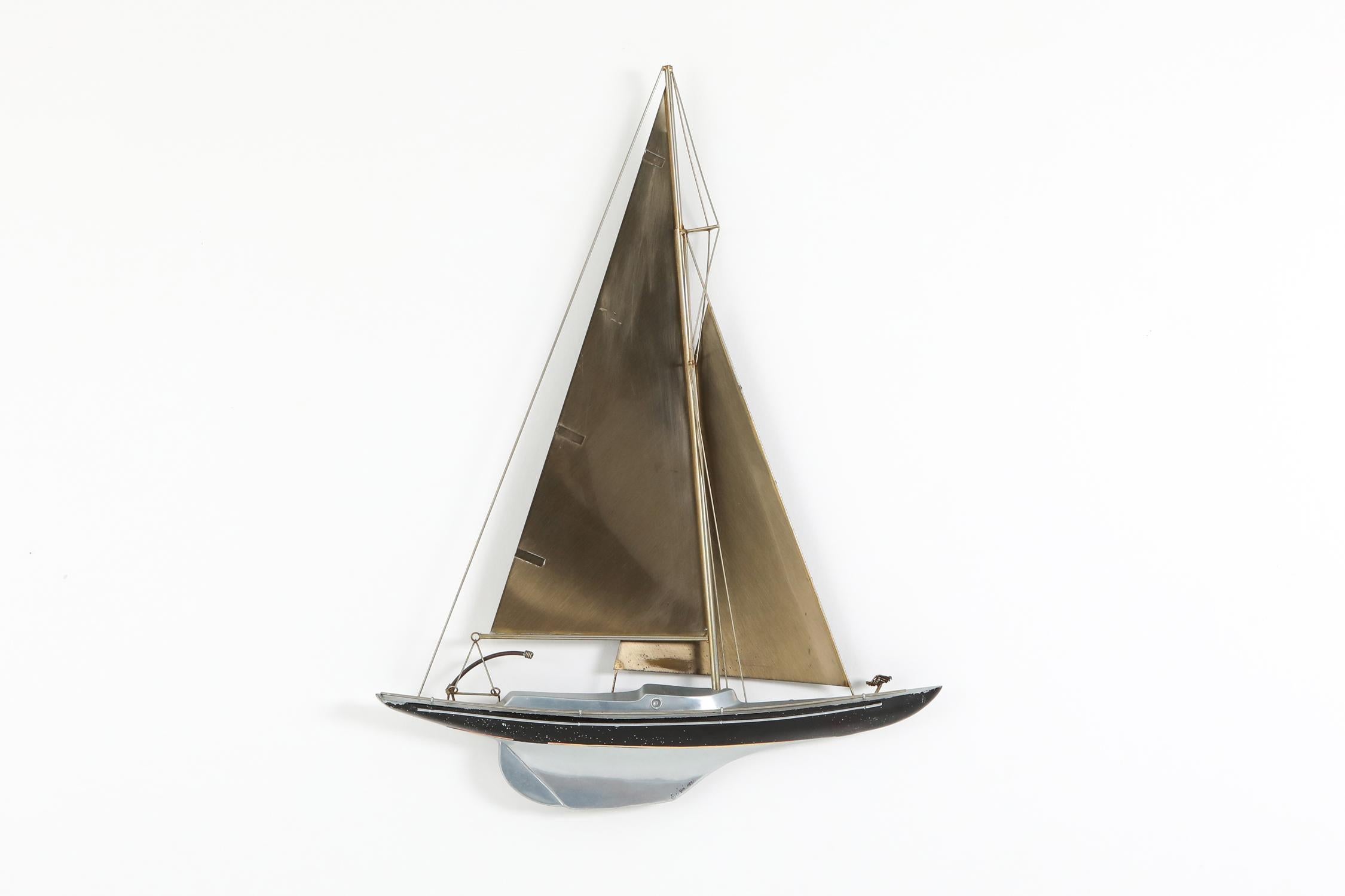 Mid-Century Modern brass and painted aluminum racing sail boat wall-mounted sculpture. Signed C. Jere 1995 and complete with authenticity papers.