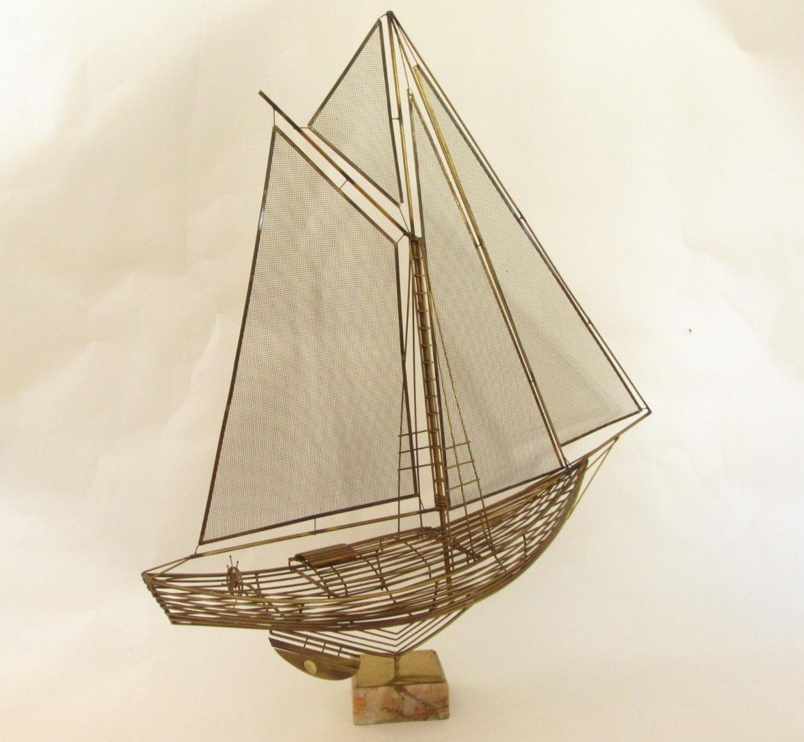 Brass sailboat sculpture on a detachable swivel platform.
Produced by Curtis Jere for Artisan House in San Francisco.