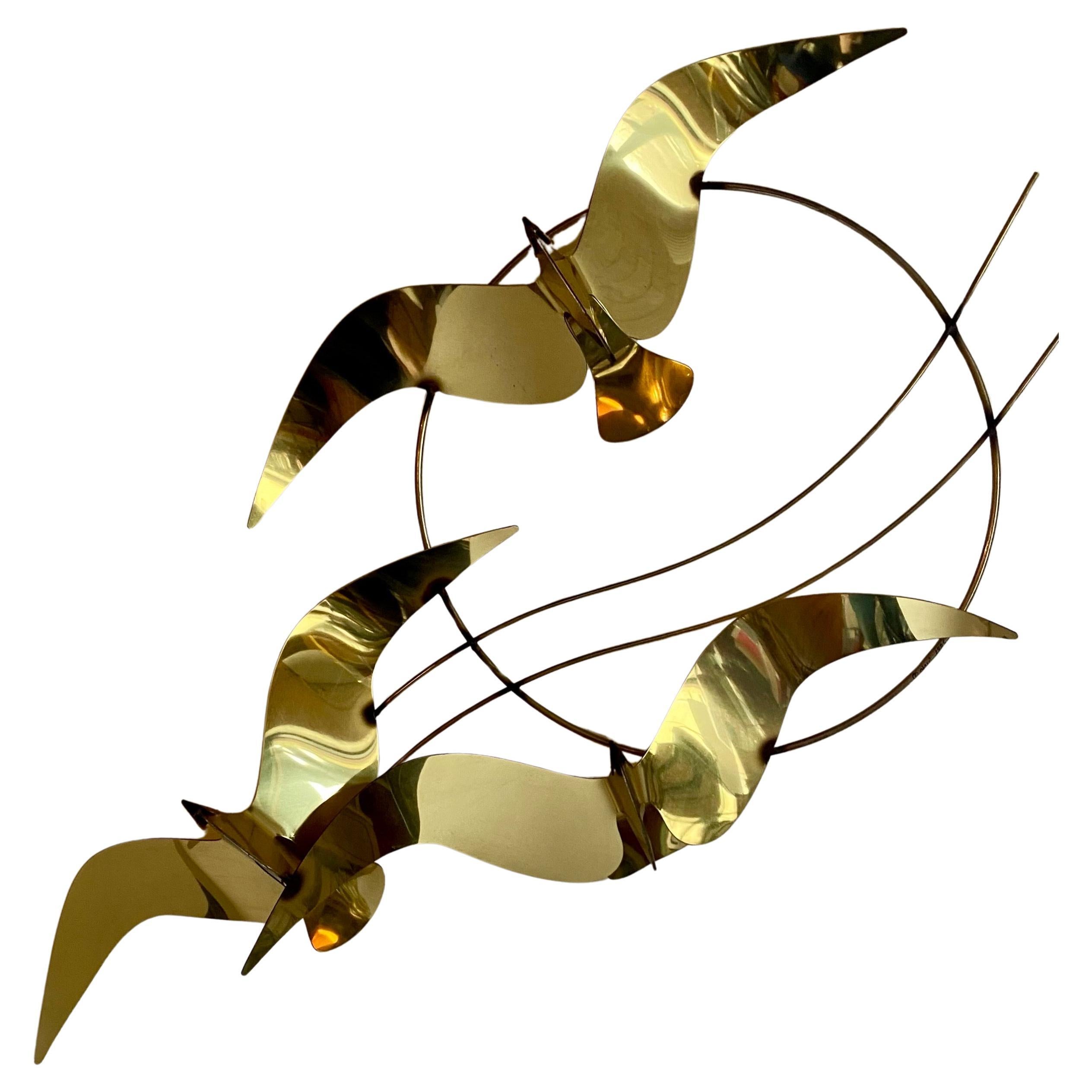 Modern abstract-form seagull wall sculpture by C. Jere, dated 1985.  This large dimensional flock of birds features a gold brass plated reflective finish.  Eyehooks on the back allow you to display this sculpture at various angles per your personal