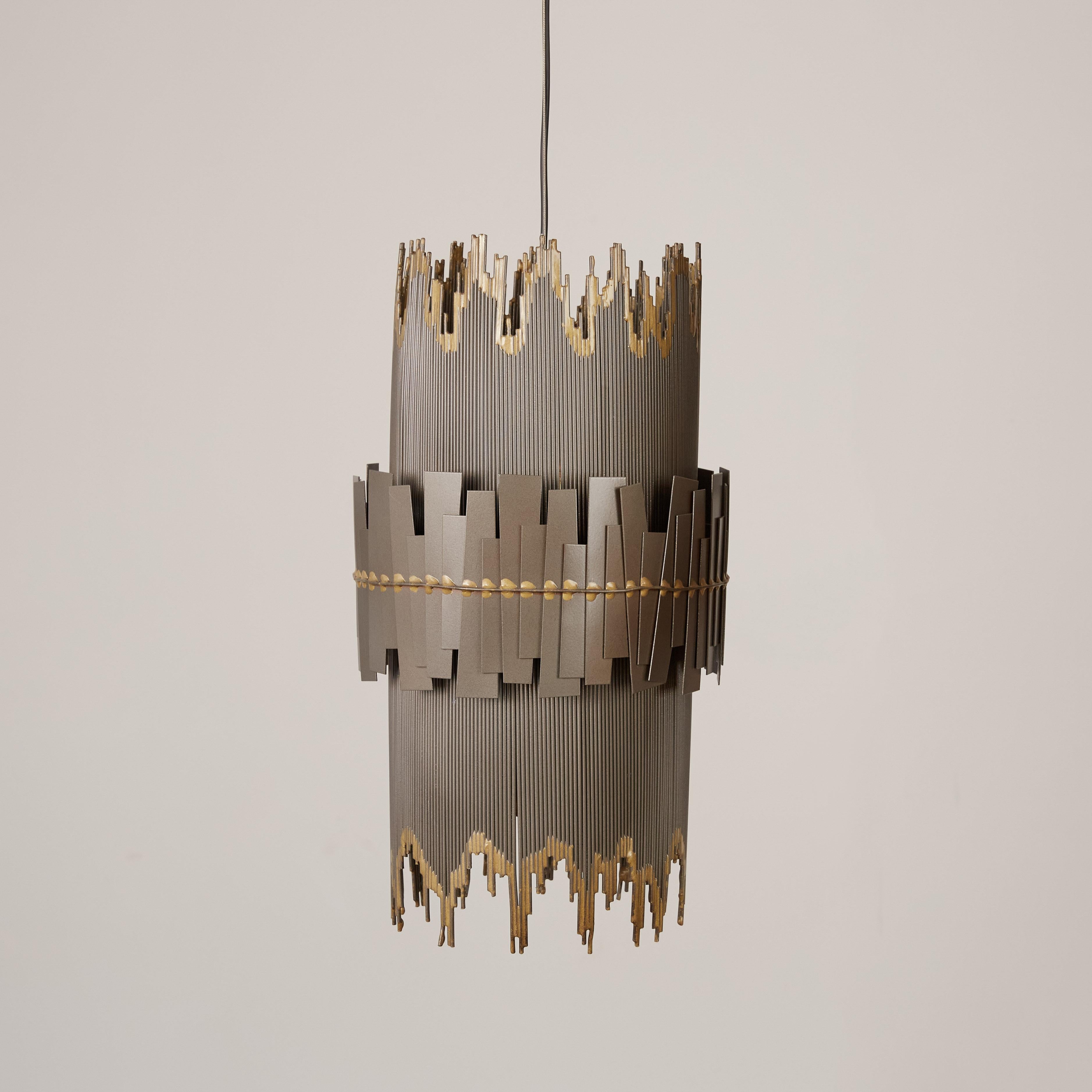 A brutalist metal pendant lamp with a cylindrical shape and irregular edges by Curtis Jeré. The main shape of the fixture has a striated frame with contrasting edges; a slightly wider ring of irregularly welded metal pieces wraps the central