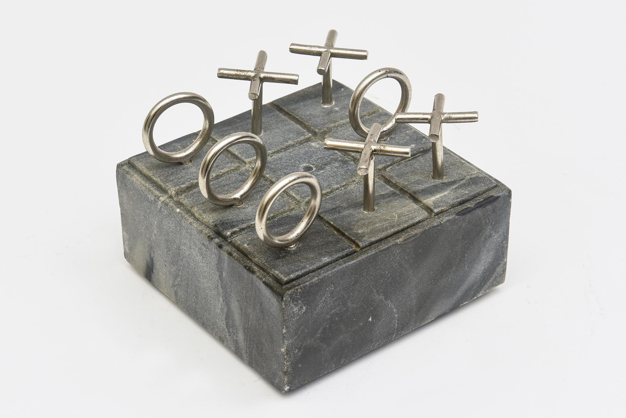 This vintage tic tac toe set game is on the original marble base. It is from the 70's. The XO players have not been re chrome plated. They have a bit of wear. The marble base is a blue black. Great also as a desk accessory.