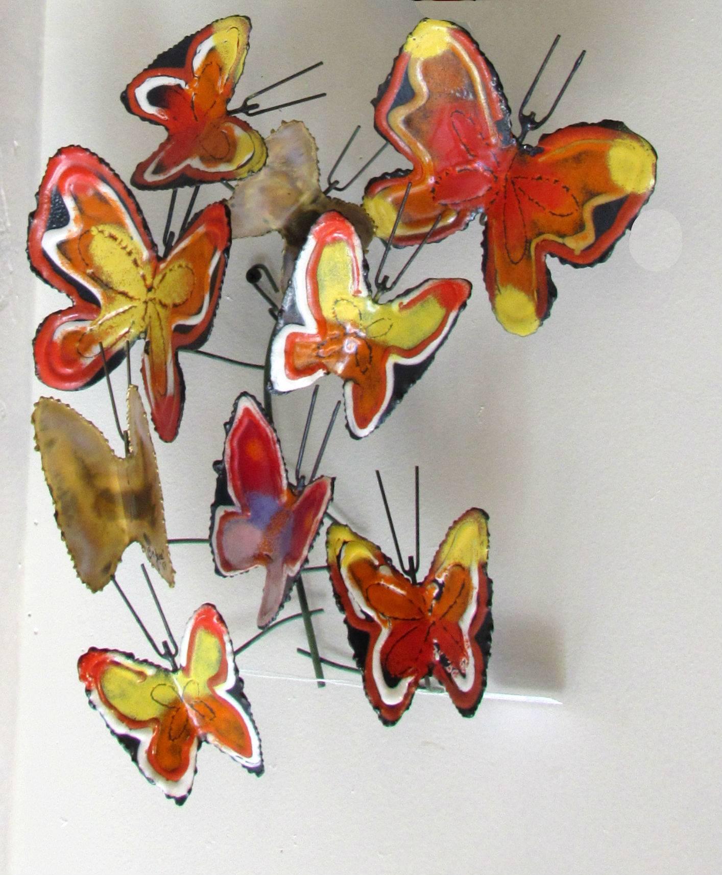 Pair of enameled wall sculptures by Curtis Jere, 1970s.  Torch cut, welded and enameled butterfly designs with vibrant yellow, orange and lavender toned enameled butterflies. 

Measurements (Each):   17