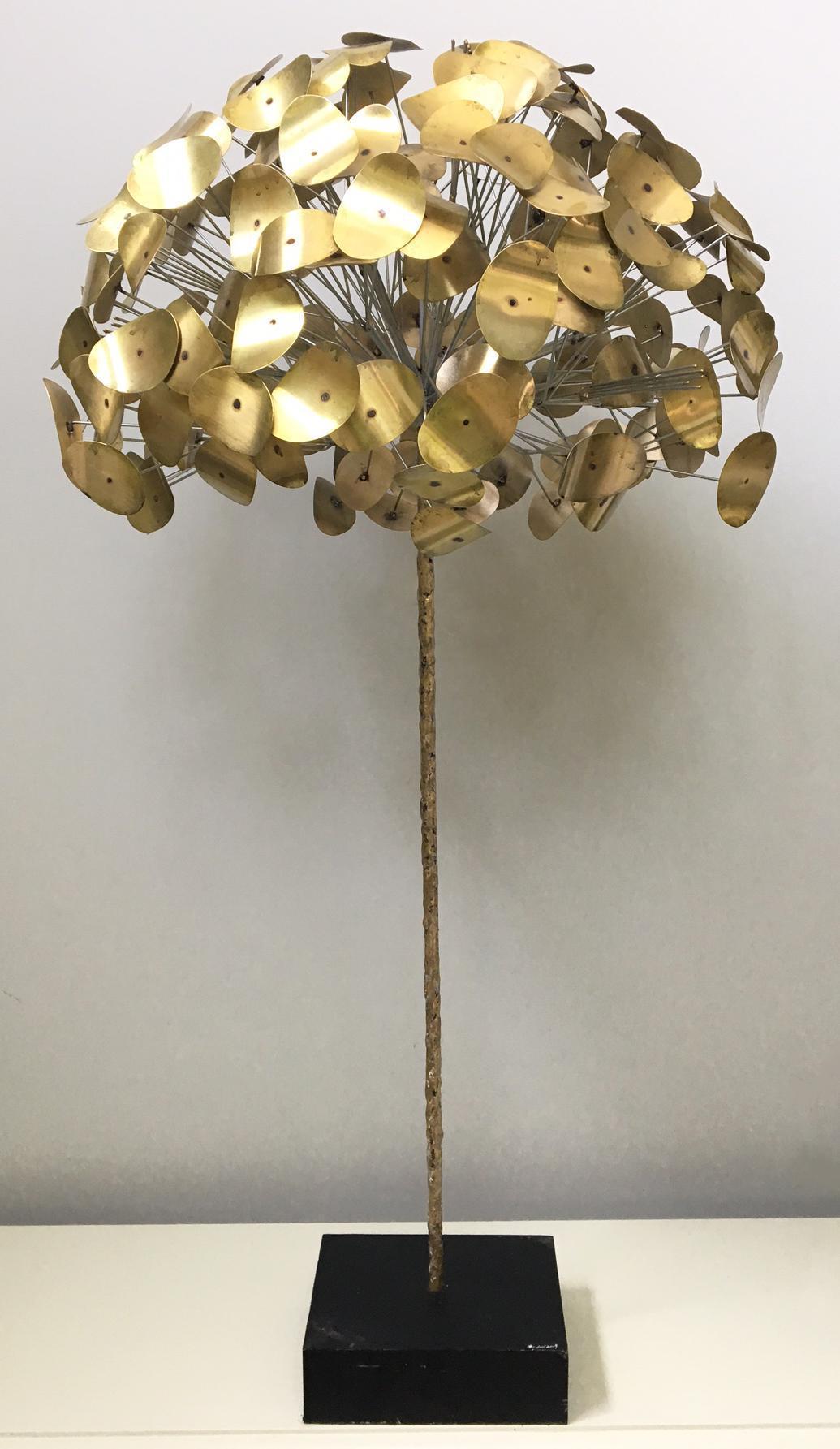 Rare Mid-Century Modern tree sculpture by C. Jere from the Raindrop series. In an exclusive partnership with Jonathan Adler, the Jere studio reissued a few iconic designs like this one.
Brass leaves on steel rods mounted in a black plinth base.