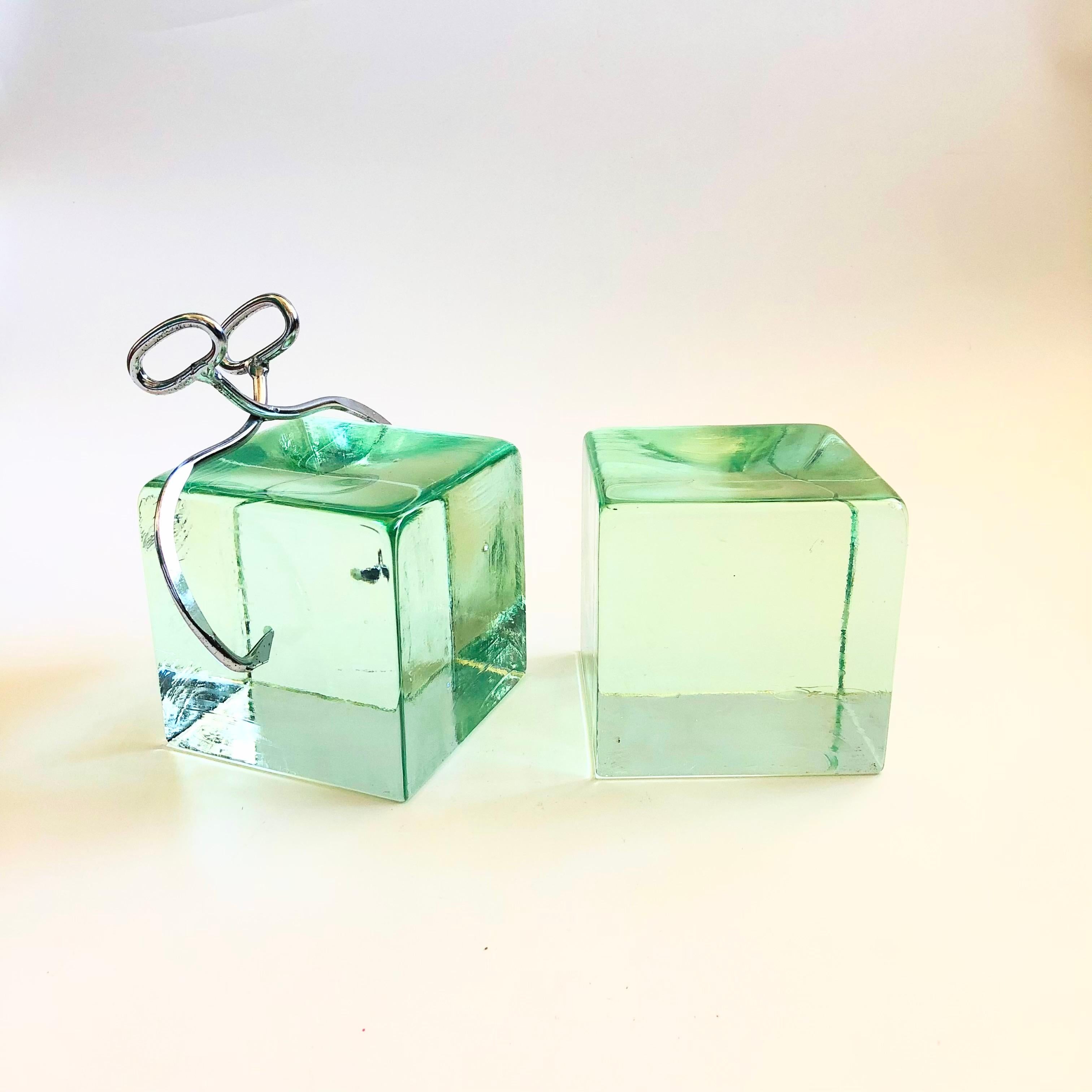 A pair of rare mid century ice block bookends by Curtis Jere. Heavy in weight with one side having chrome tongs. No signature.
Measurements:
Piece with Tongs: 6