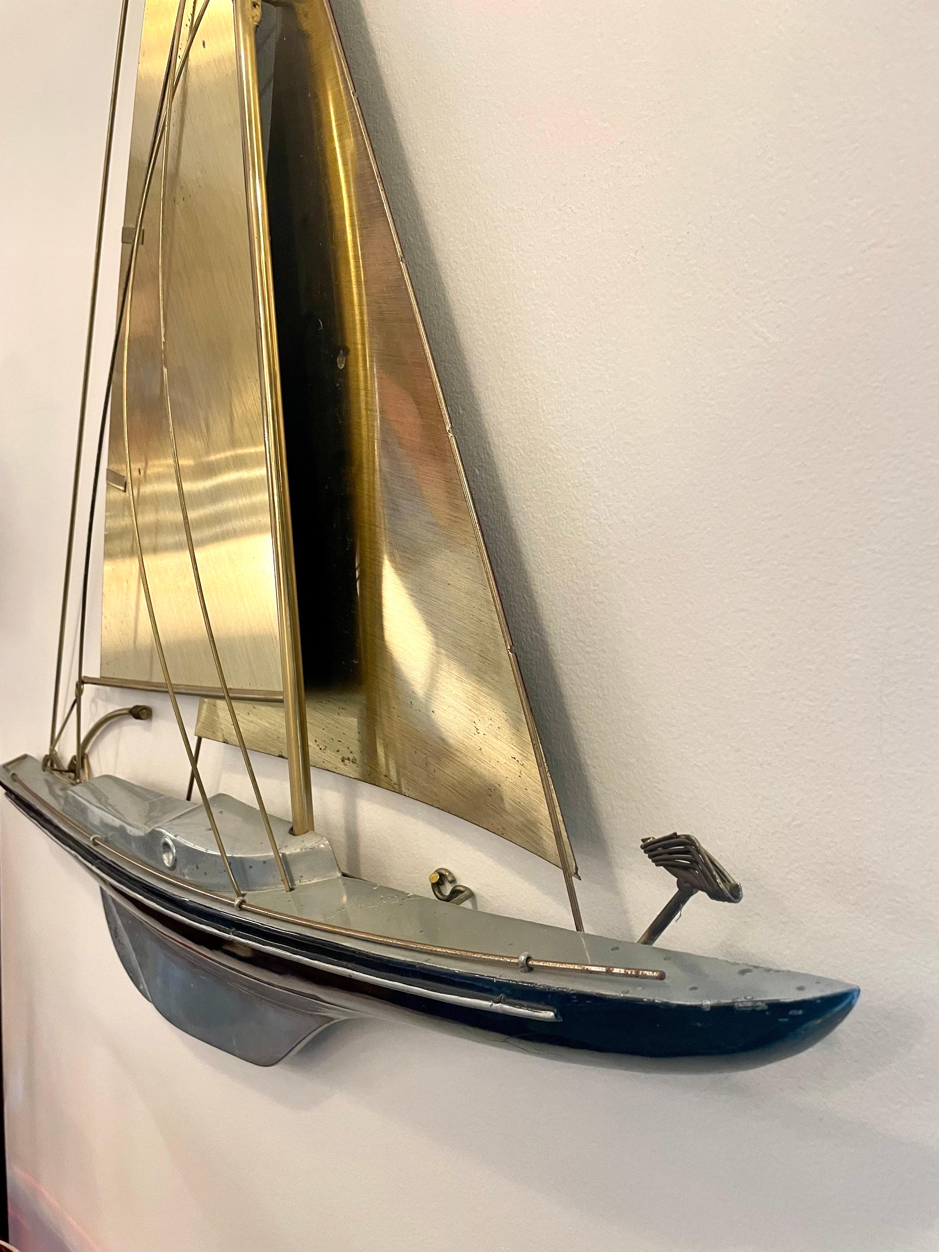 This wonderful large wall sculpture of a maritime racing sailboat is signed by Curtis Jere for Artisan House. 