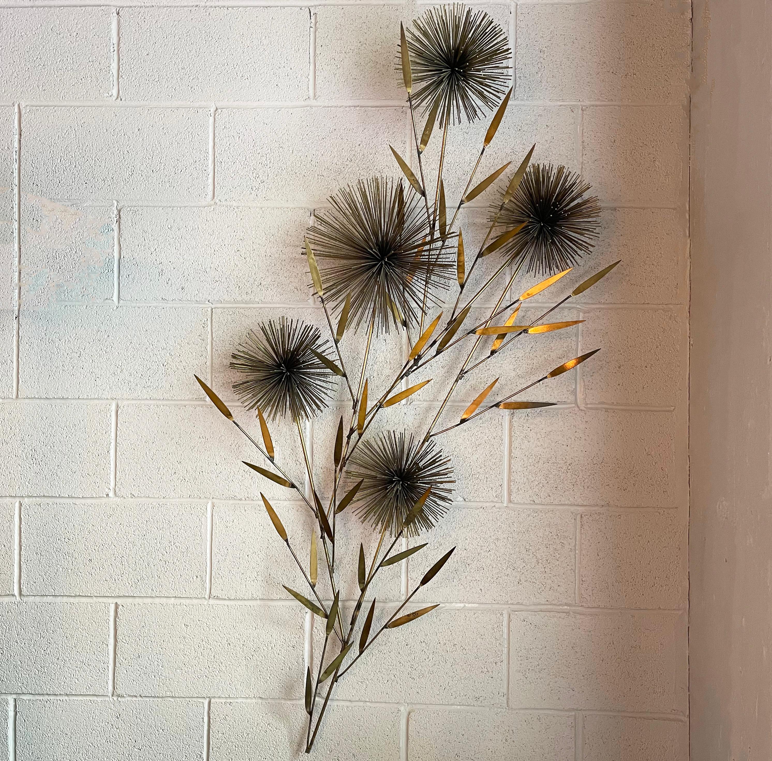 Large, midcentury modern, floral motif, brass wall mounted sculpture by Curtis Jeré features five cascading pom-pom flowers amid delicate leaves. 