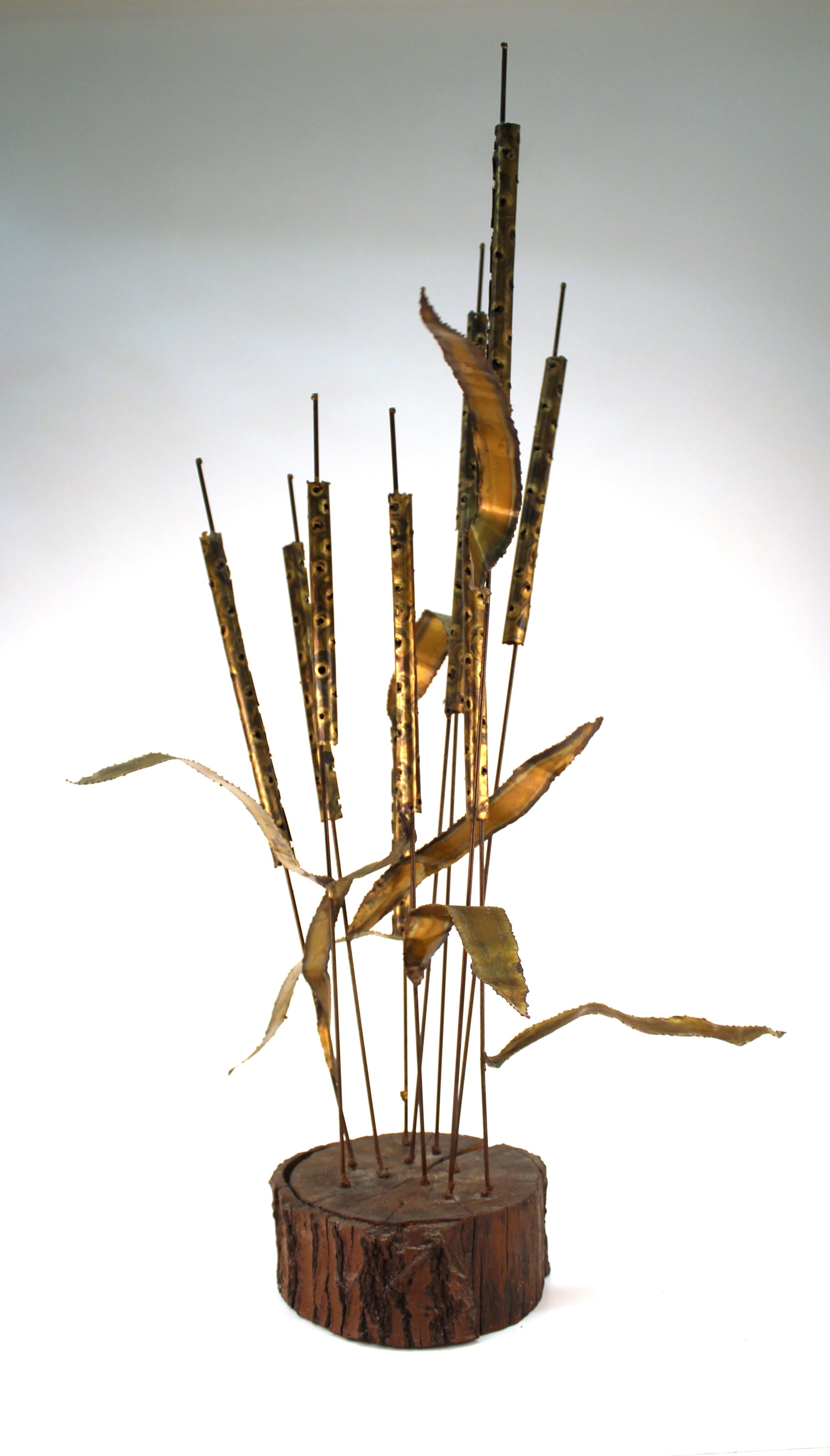 Curtis Jere manner Mid-Century Modern brass cattail sculpture on wood base. The piece is in good vintage condition.