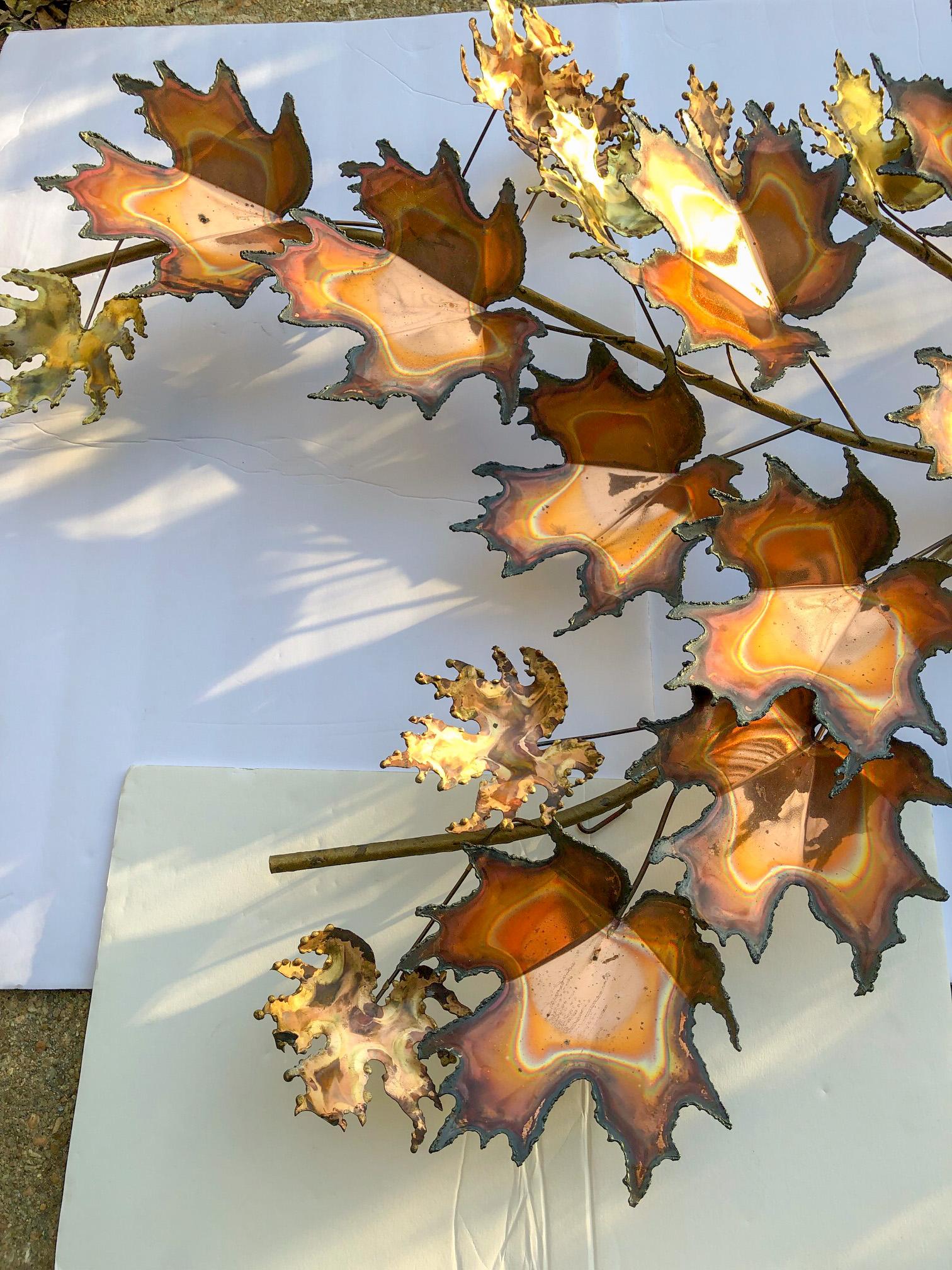 Large scale multi dimensional torched copper and brass wall hanging by famed metal artist C. Jere. Signed and dated 1971. Mid-Century Modern maple leaf wall decor has attached loops on the back for hanging. Sculpture may be hung as photographed, or
