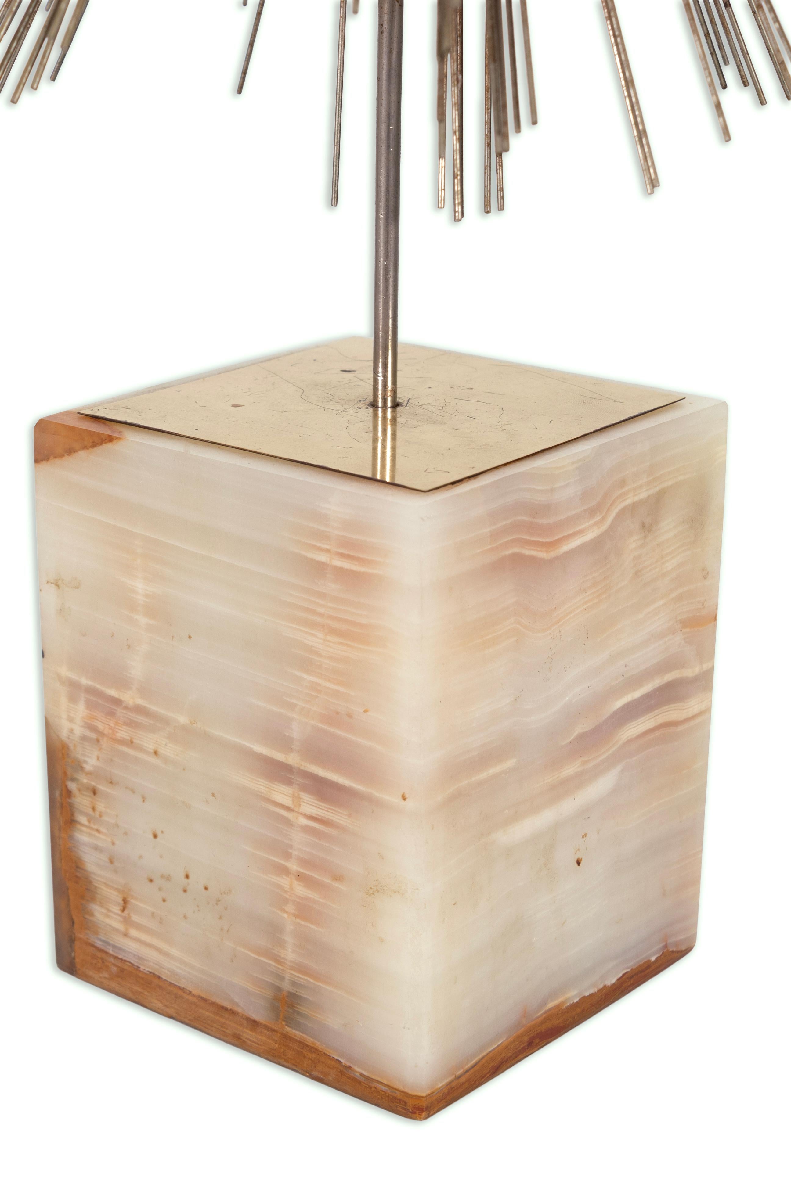 A striking example of mid-century modern design, this Curtis Jere Dandelion Burst sculpture radiates dynamic energy and sculptural elegance. Dozens of metal rods extend outward in a bold spherical explosion, mimicking the delicate beauty of a