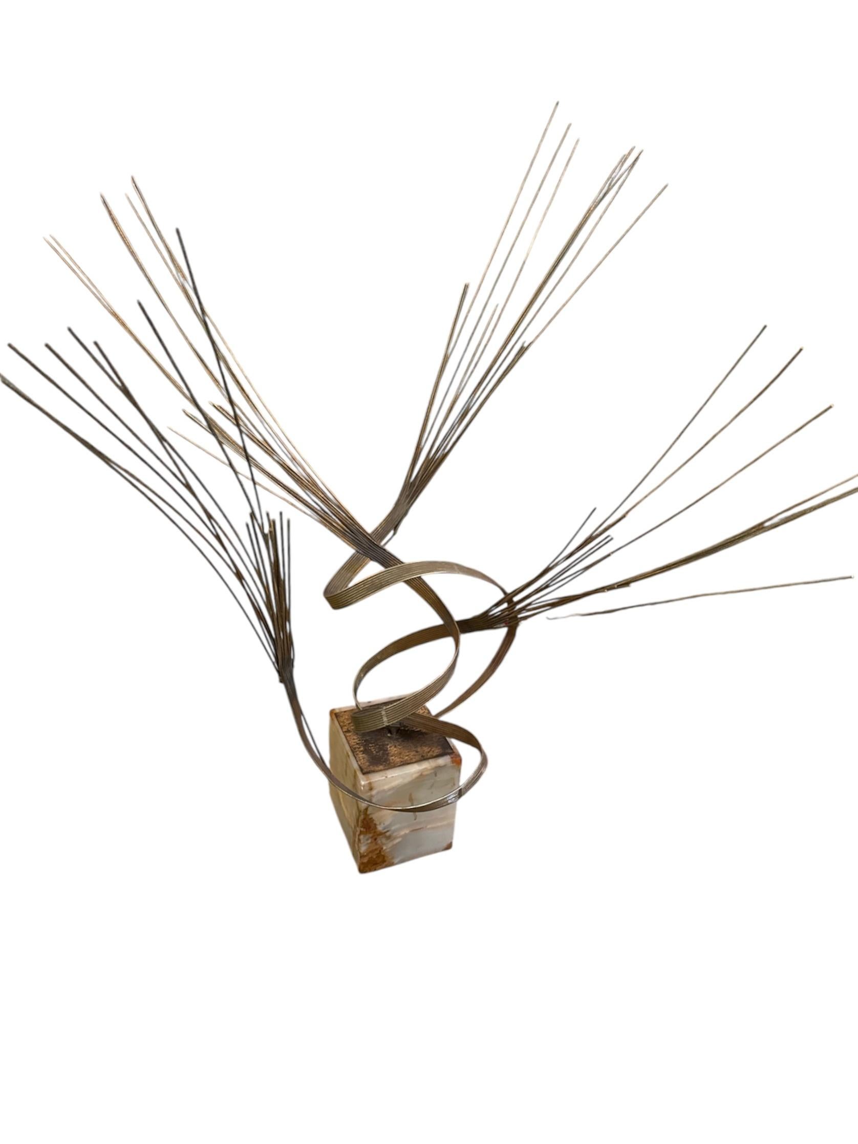 Infuse your space with the dynamic artistry of this striking Curtis Jere mid-century modern brass sculpture. A captivating example of the renowned artisan collective’s innovative designs, this piece bursts with movement and sculptural elegance,