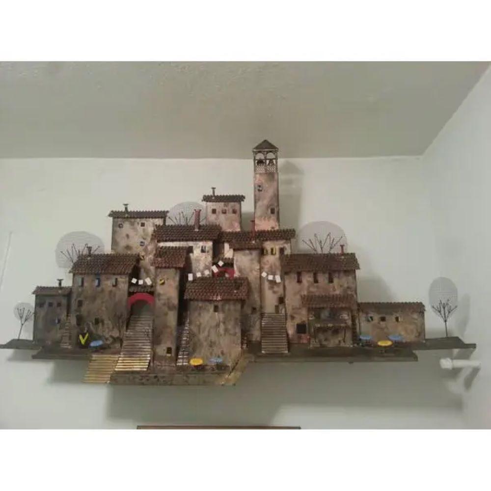 1960s Vintage Village and Cafe Scape Wall Sculpture by Curtis Jere.
Mixed Metal Village / Cafe Scene Signed C. Jere.

Beautiful Cosmopolitan Village Of Eclectic Mixture Of Metals. A Depiction Of A Romantic Quaint Life Of Cafe Romances Or European