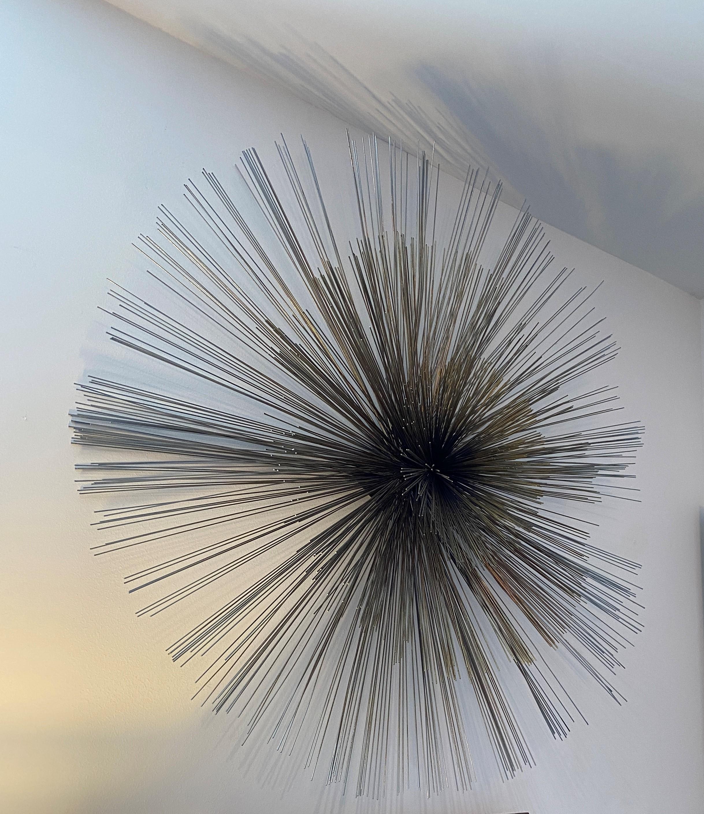 This stylish and iconic Pom Pom wall mount sculpture by Curtis Jere captures the 1960s-1970s with its architectural form and whimsical nature. The piece is fabricated in stainless steel and brass plated steel.

Note: See last image showing the