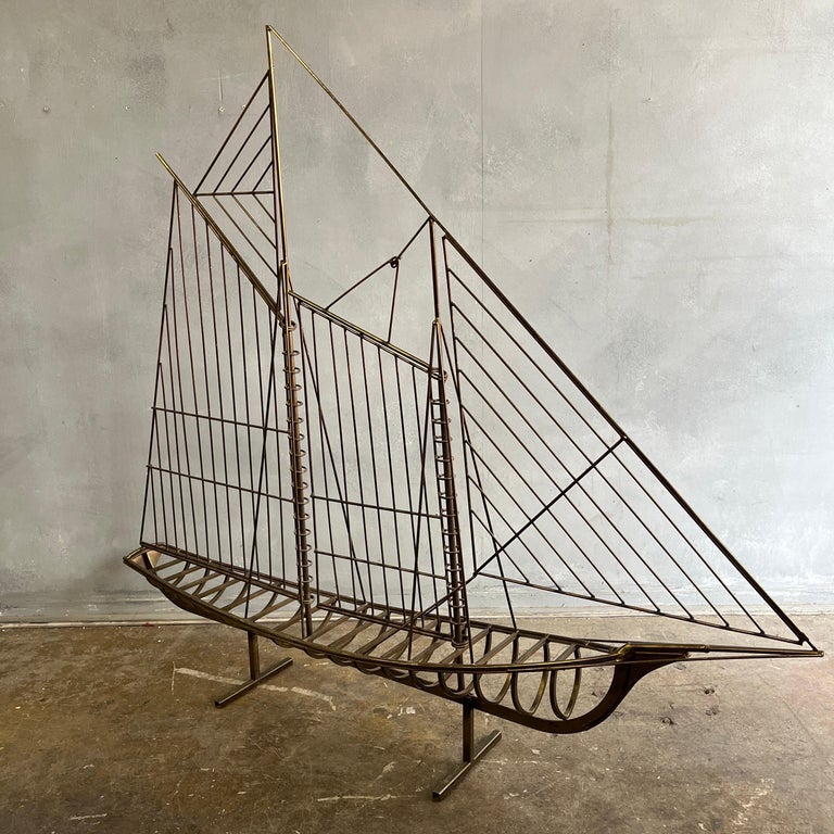 Wonderful midcentury sculpture of a sailboat by famed sculptor Curtis Jere. Showing original and untouched patina. A wonderful addition to your collection and one of his most striking designs. 

Can be wall mounted or placed on the floor. Legs to