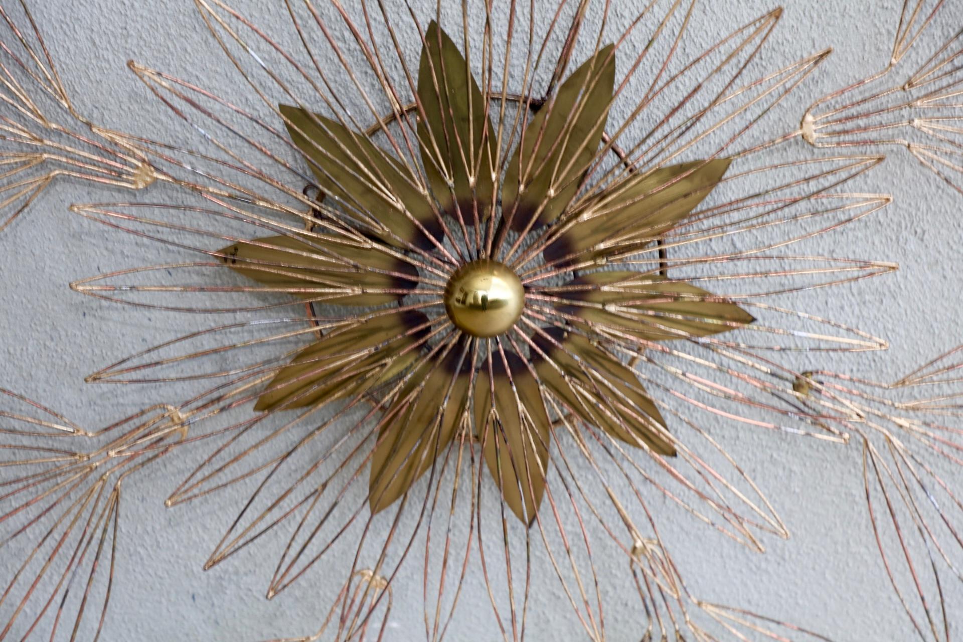 A nice signed Curtis Jere wire wall sculpture in the shape of a star blossom. it is signed and dated 1980. This piece appears to have clearly been touched up, but it is an unusual one and large at almost 4 feet in diameter.