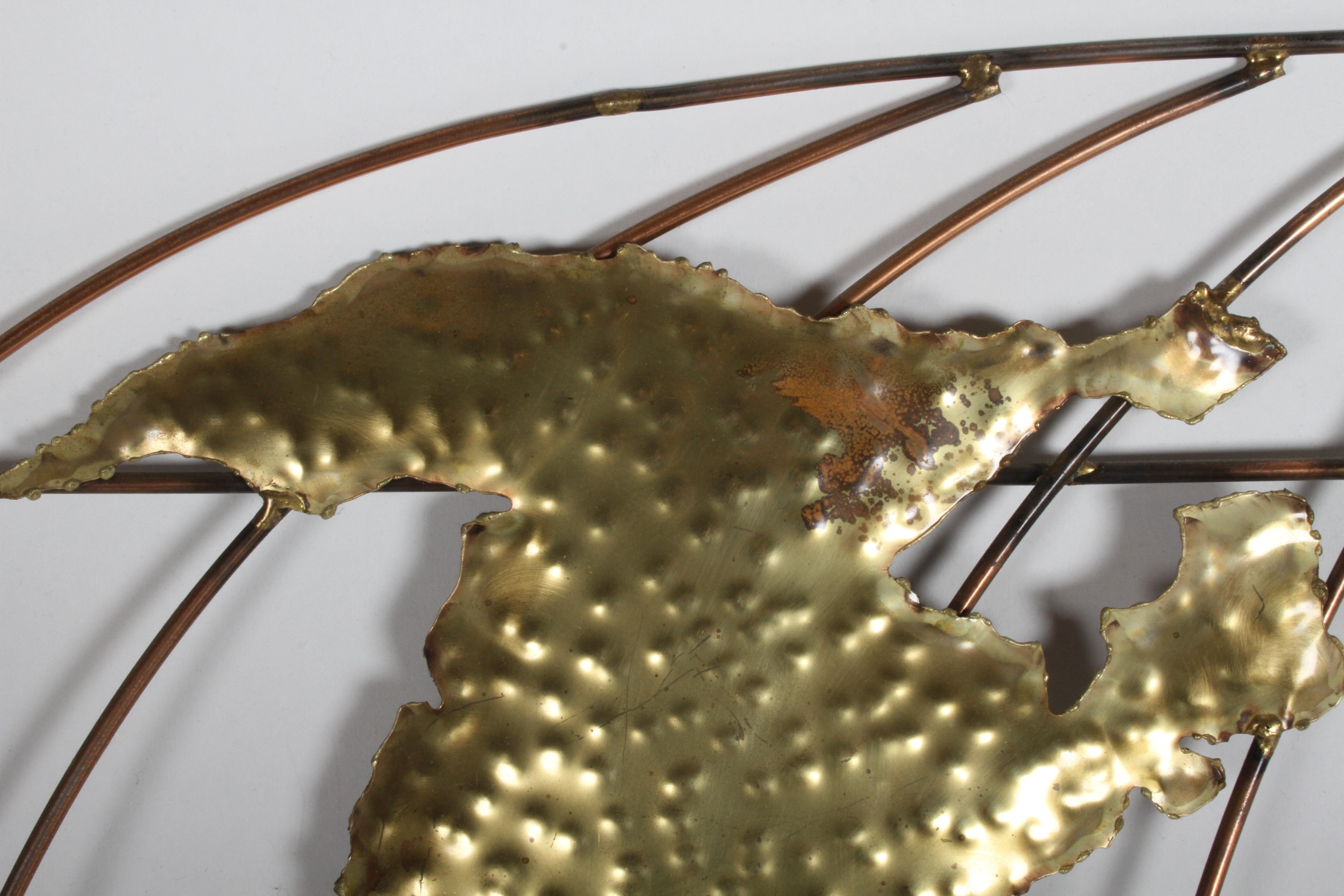 1970s world hemisphere map, made of copper and textured brass with artisan signature Faye in black ink. Overall very nice condition, some light patina. Has three mounting hooks on verso.