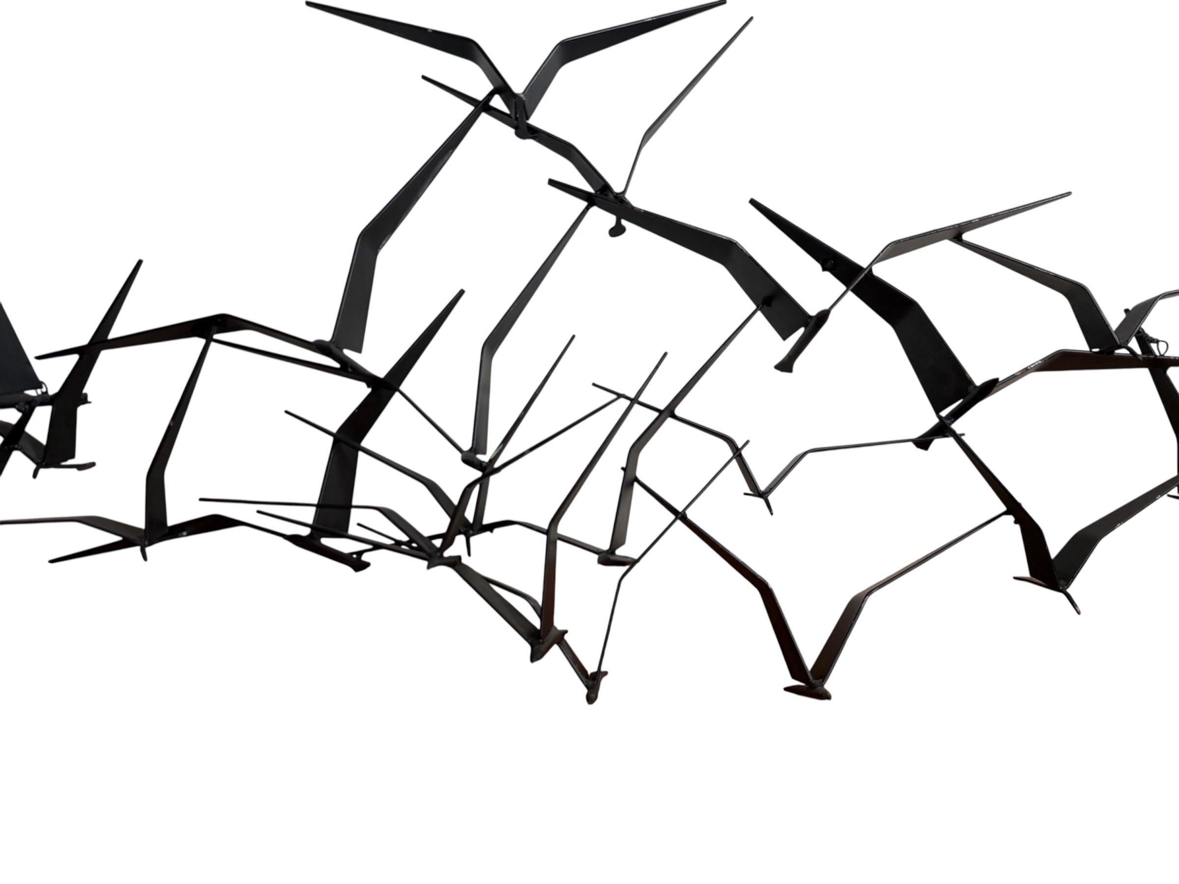 A nice modernist piece comprised of welded abstract birds, layered into a striking three dimensional flock with the appearance of flight.

Condition Report:
In very good vintage condition. There is one loose weld spot but it doesn't affect the look