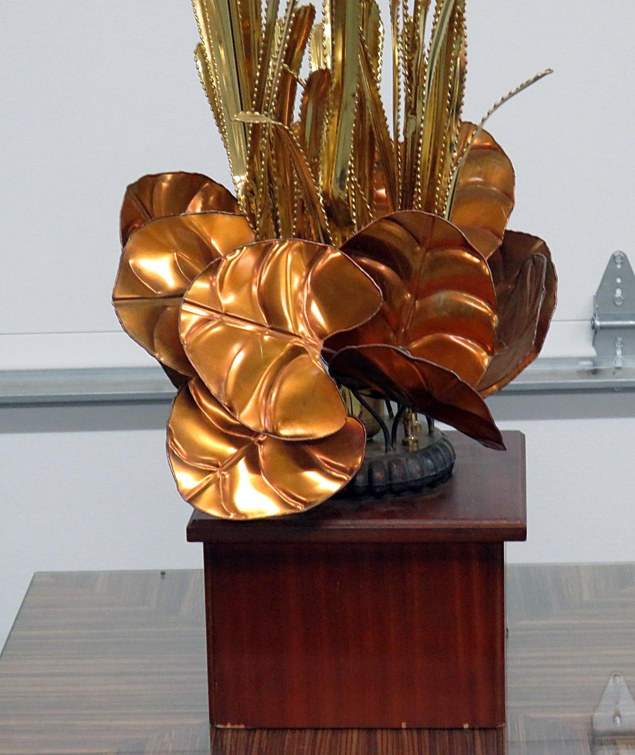 Curtis Jere style mixed metal lamp featuring lily pads and reeds on a wooden base.