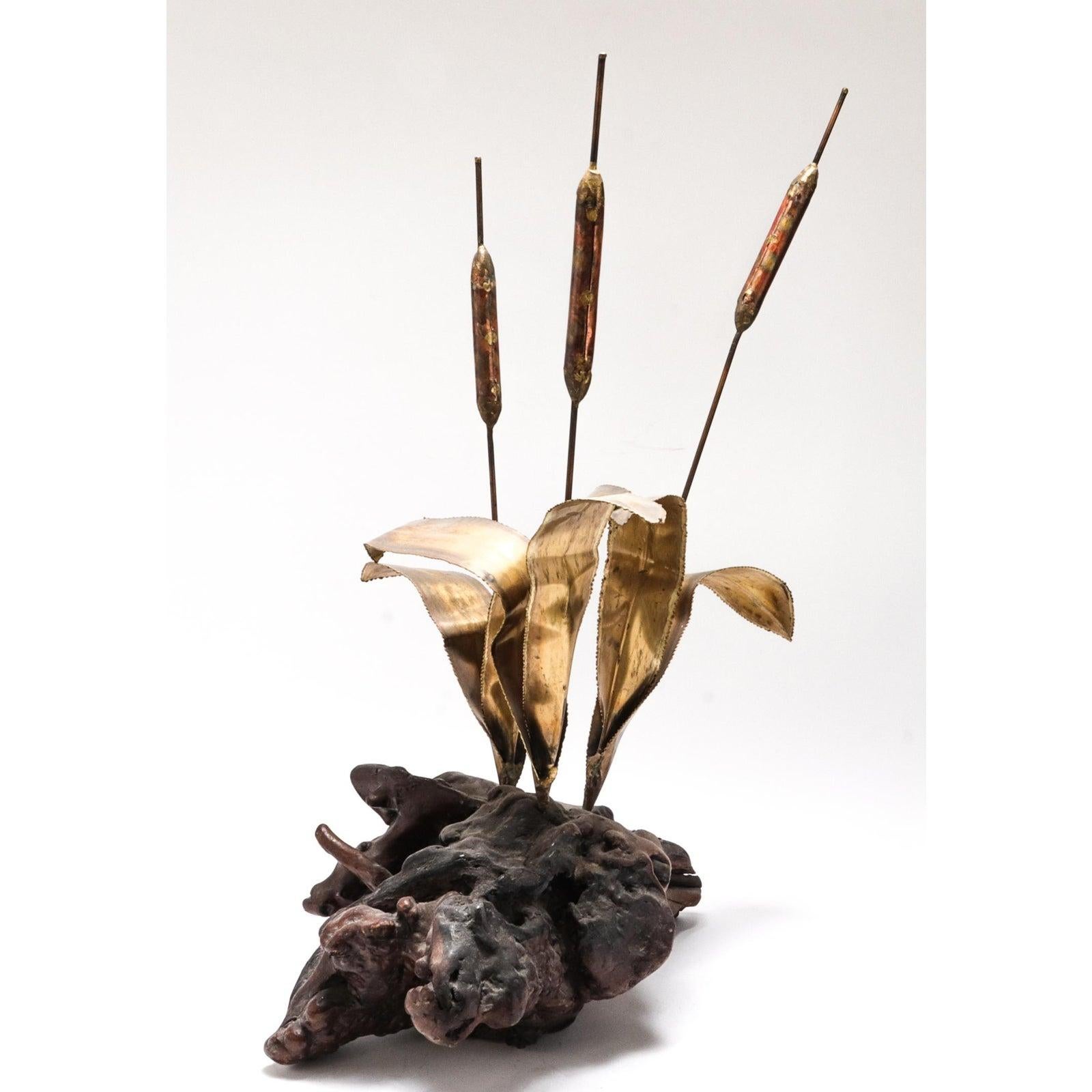 Modern brass metal cattail sculpture attached to root base, in the manner of Curtis Jeré. In great vintage condition with age-appropriate wear and use. 28.25
