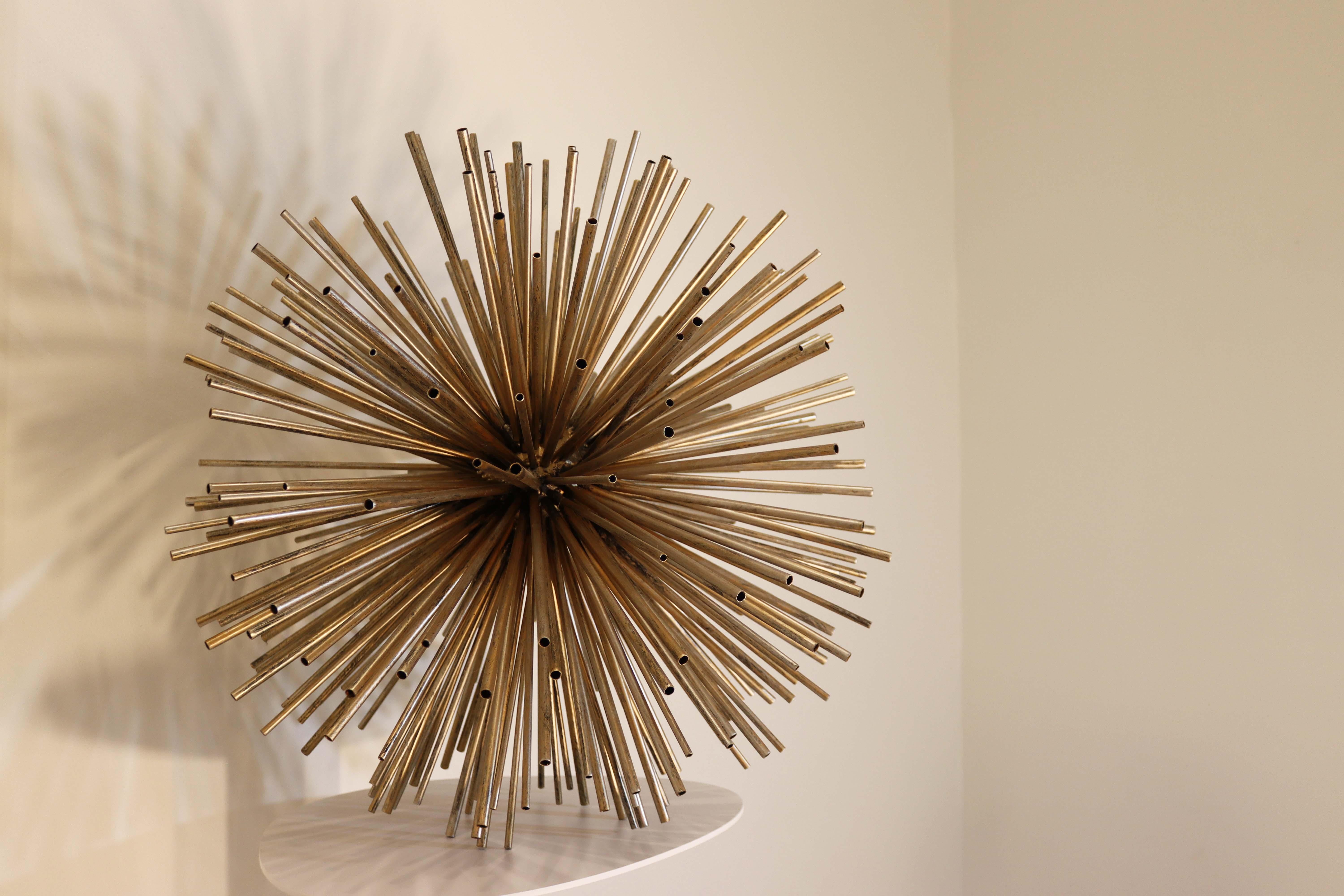 This large, sputnik metal-work sculpture, also referred to as a sunburst or pom pom style and made famous by Curtis Jere, is a stunning piece of art which works well in any aesthetics from Mid-Century Modern to Contemporary styles. Measuring at