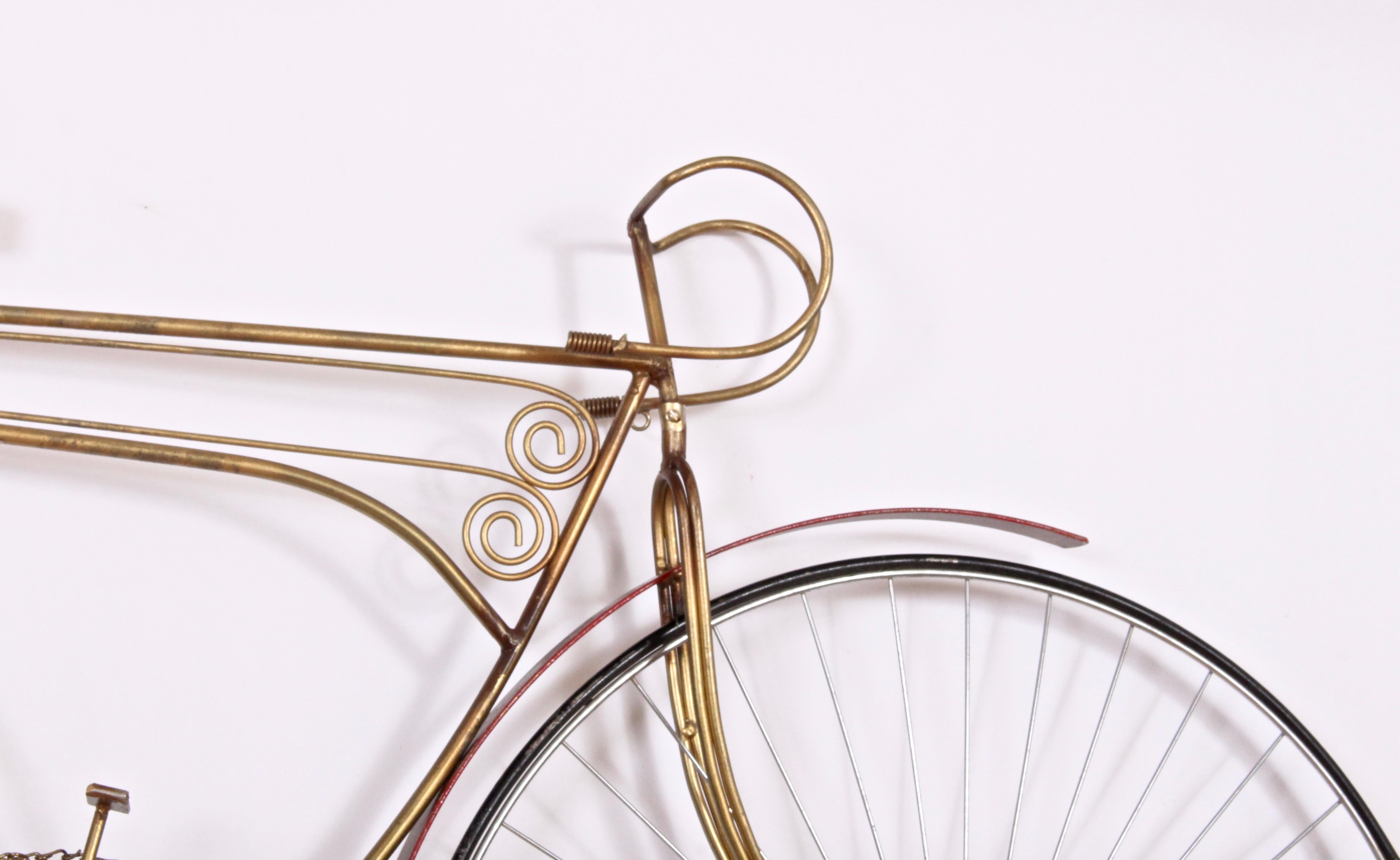 Large Bicycle Wall Relief Sculpture by Curtis Jere, 1986. Featuring a Gold and Red painted Iron and Wire frame, Red painted wooden seat and Black painted wheels. Wheels turn, spin. Minimalist. Rarity. Signed, C. Jere 1986.
