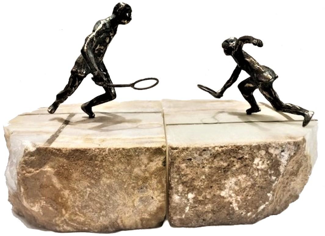 This unusual pair of bookends depicts a friendly tennis match. Both signed C. Jeré, they feature an unusual selection of materials used – bronze and onyx. 

C. Jeré (or Curtis Jere) is a metalwork company of wall sculptures and household