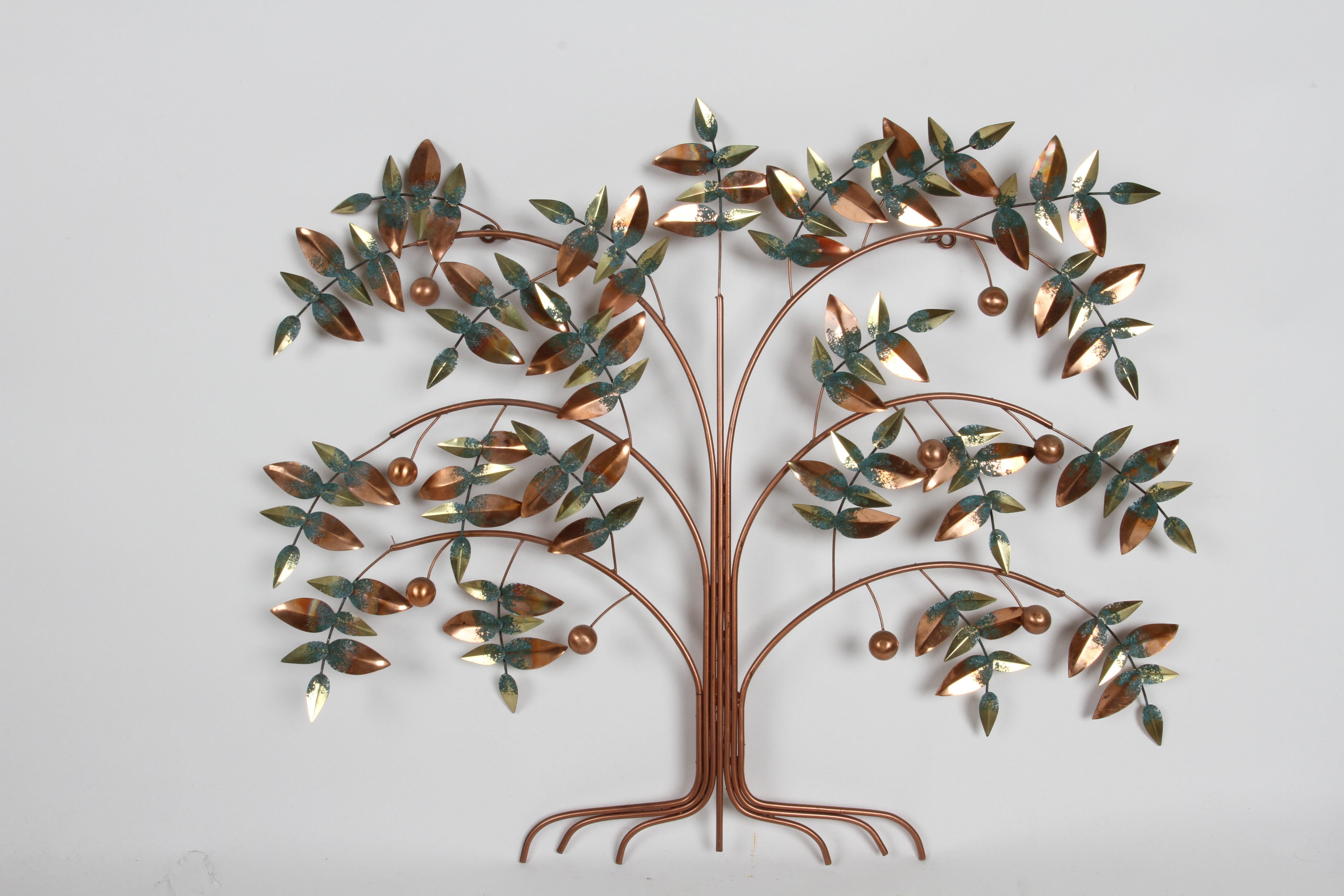 Tree of life wall sculpture in copper toned metal with verdigris highlights on leaves and copper ball fruit. Faded signature C. Jere and dated 1977. In very nice condition, bright and fresh. 