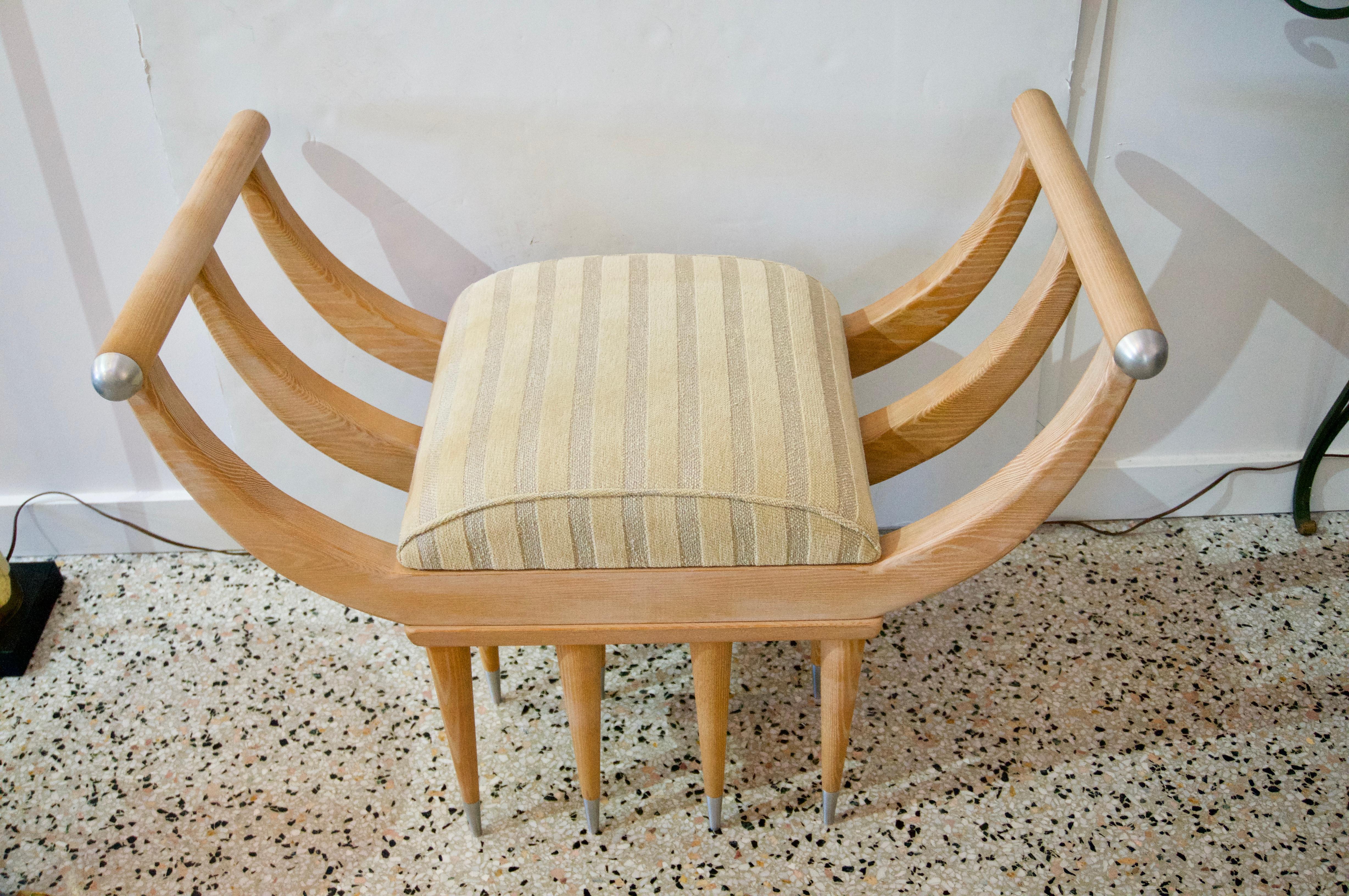 This stylish and very chic bench was custom designed and was acquired from a Palm Beach estate and will make a definite statement with its one-of-a-kind form and finish.

The piece is fabricated in oak with stainless steel accents.

Note: The