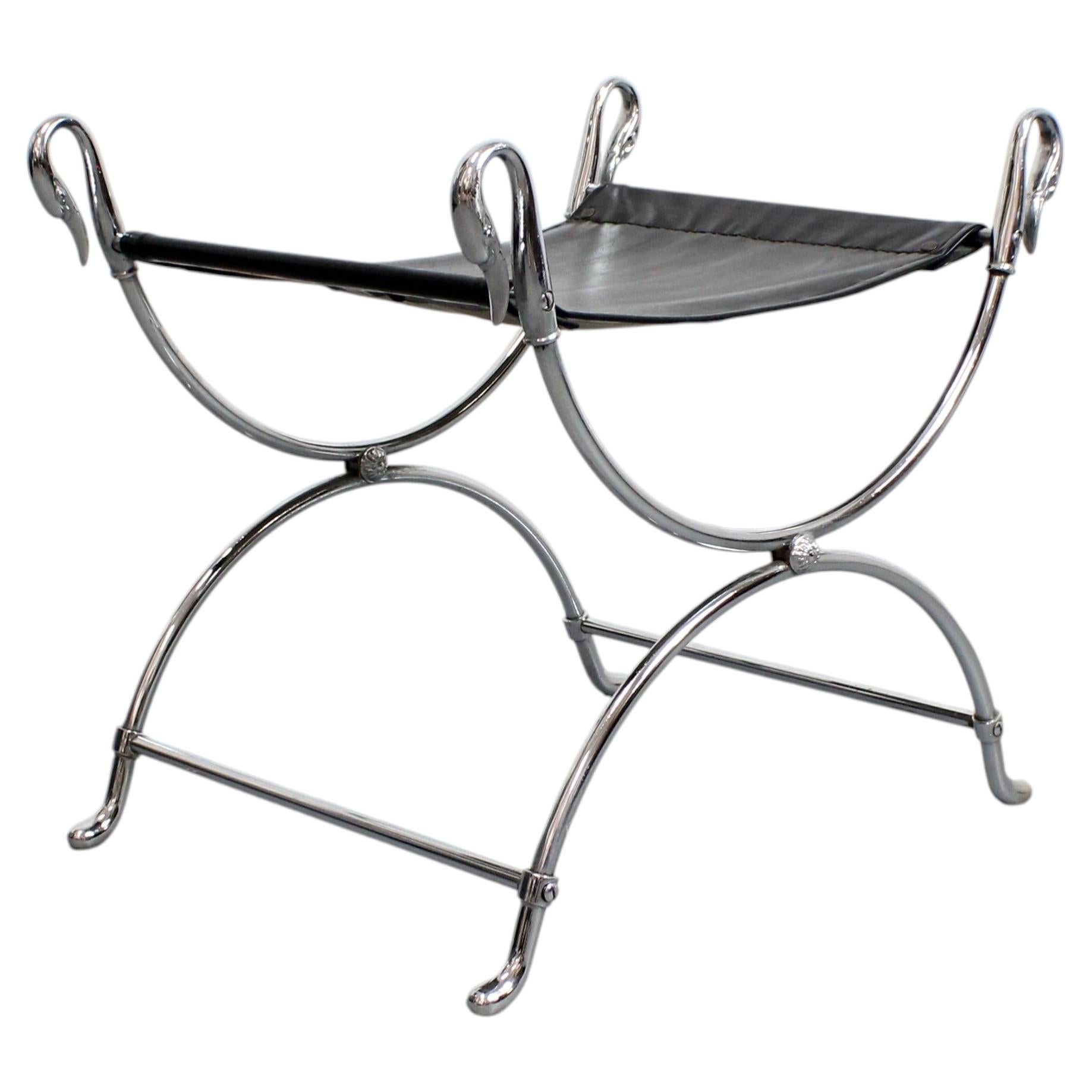 Curule stool in chromed steel, adorned with swan heads and a black seat