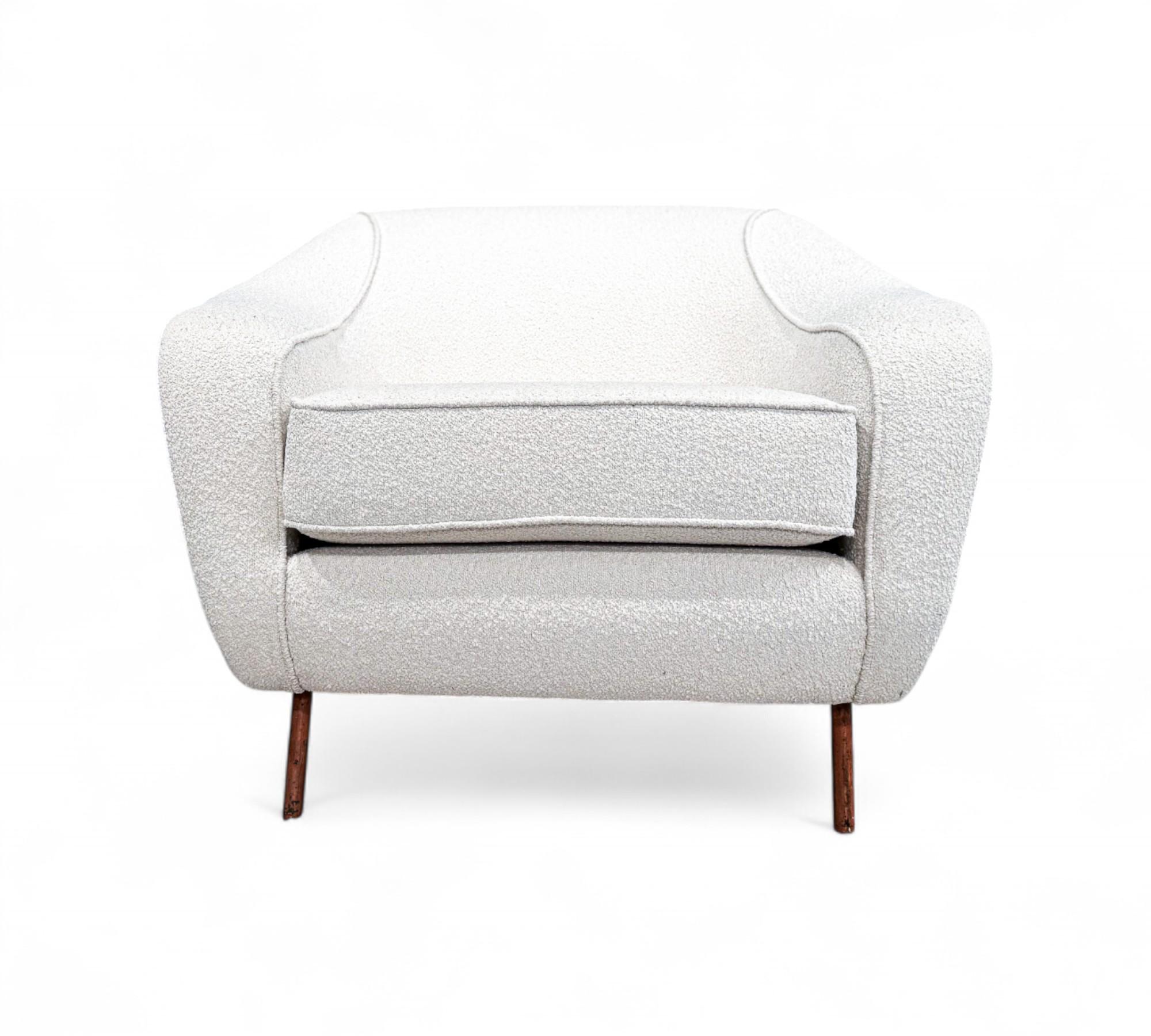 Introducing the iconic Curva armchair, originally conceived in the 1960s by the renowned Joaquim Tenreiro for Tenreiro Moveis e Decoraçaos. This timeless piece masterfully blends width and inviting form to provide unparalleled comfort, making it a