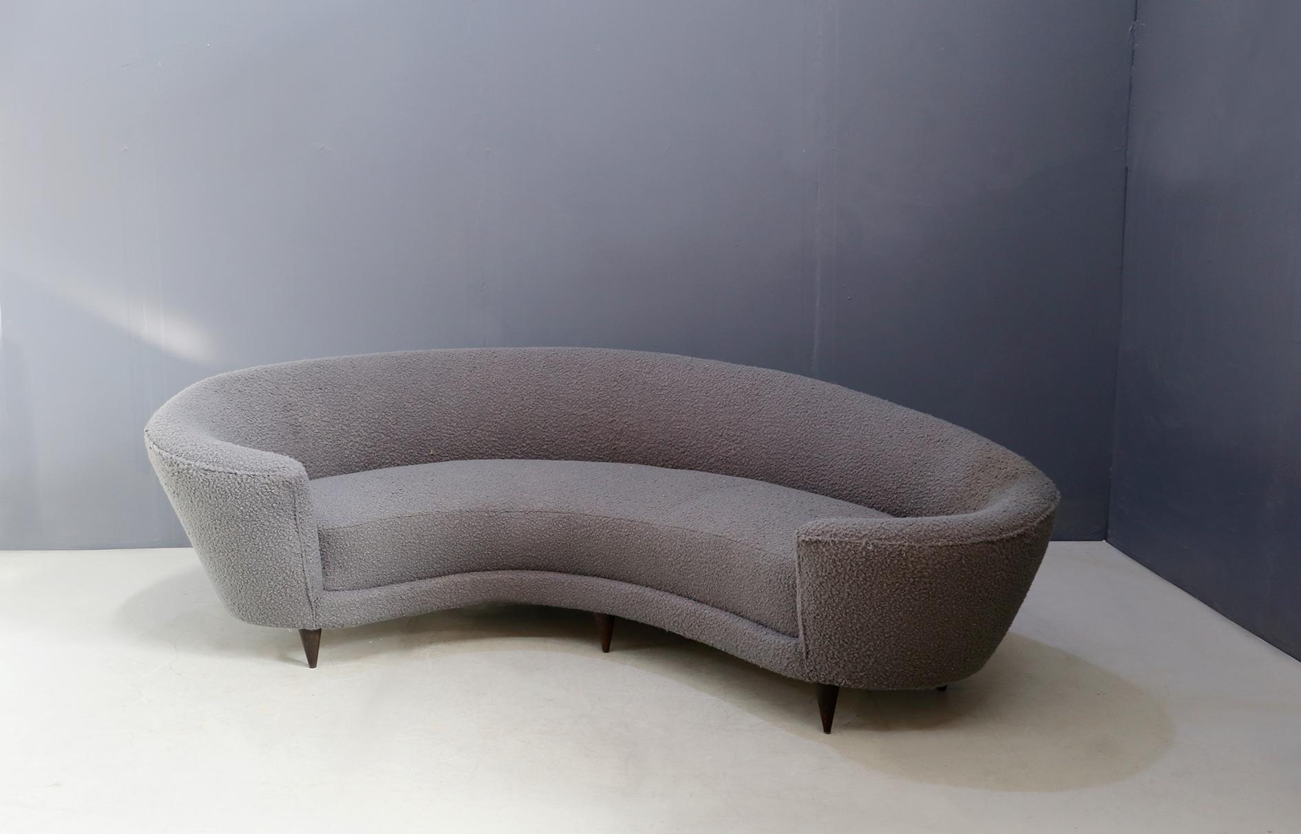 Curva sofa by Federico Munari in grey bouclè fabric, 1950s. The sofa has original springs and structure. The sofa is lined with grey bouclè fabric. The sofa is called Curva because of its curved shape. Its feet are made of wood with conical shape.