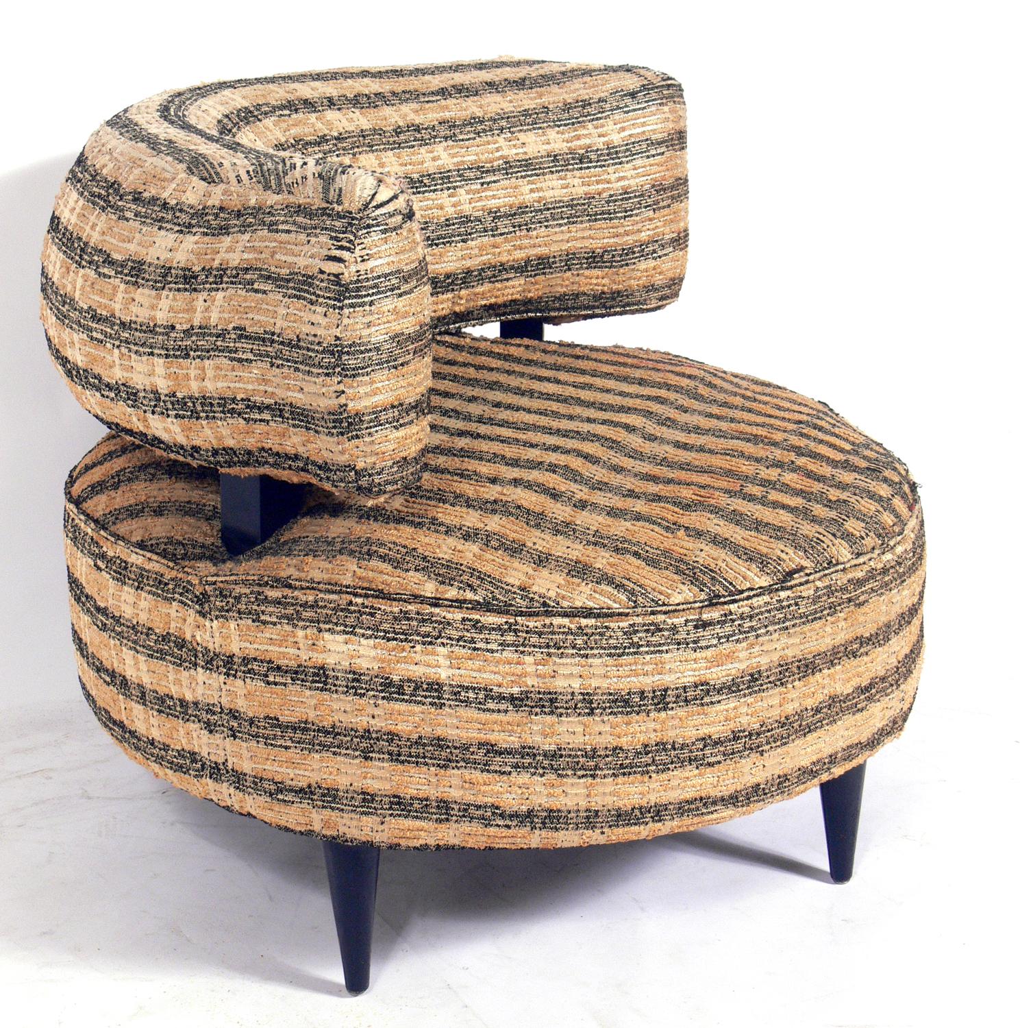 Curvaceous 1940s lounge chair, in the manner of Gilbert Rohde, American, circa 1940s. This piece is currently being reupholstered and refinished and can be completed in your choice of finish color and reupholstered in your fabric. The price noted