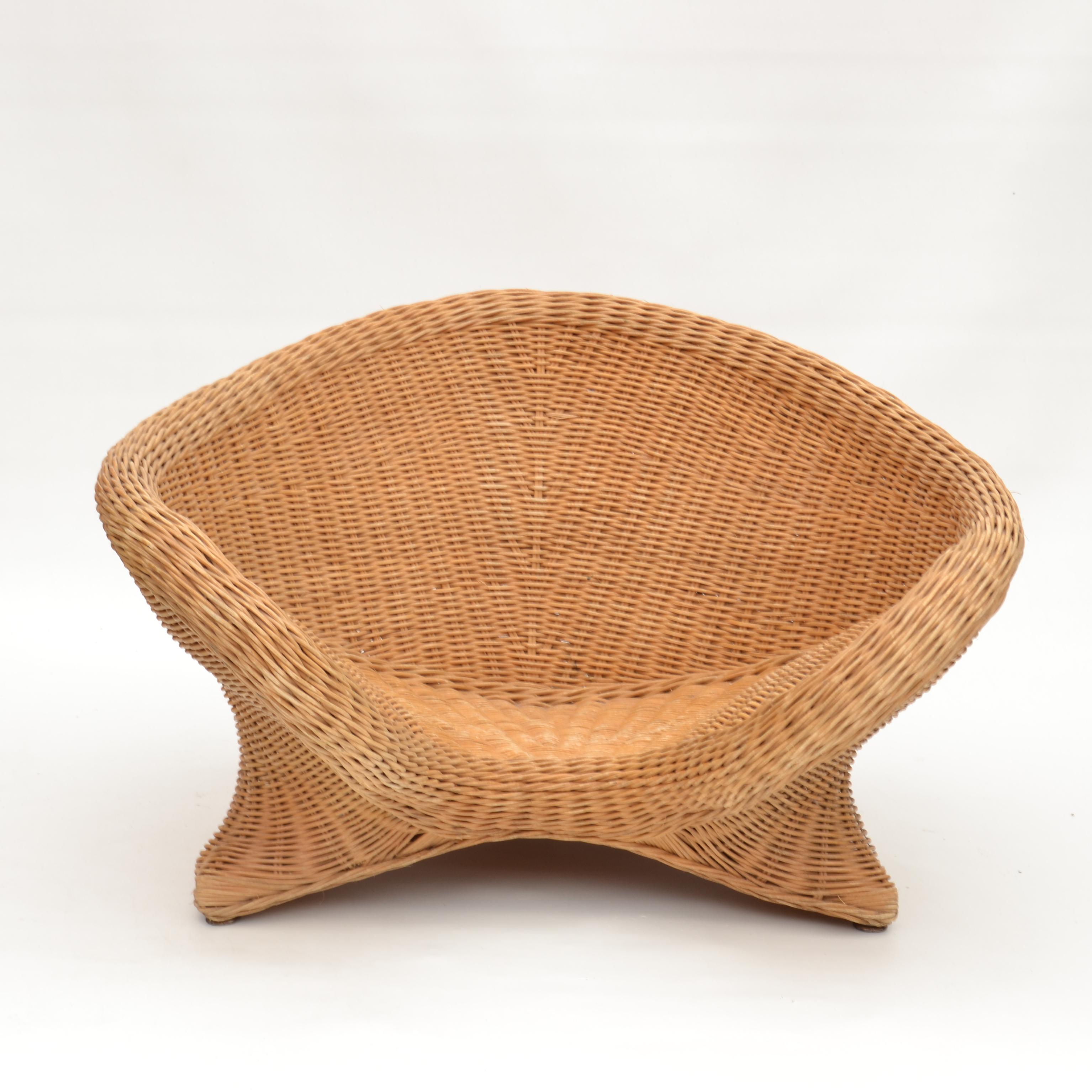 Rattan lounge chair hand woven for in or outdoors made by high skilled cane weaver over a bamboo inner construction. Comfortable curvaceous low chair, ideal in the garden or by the pool.